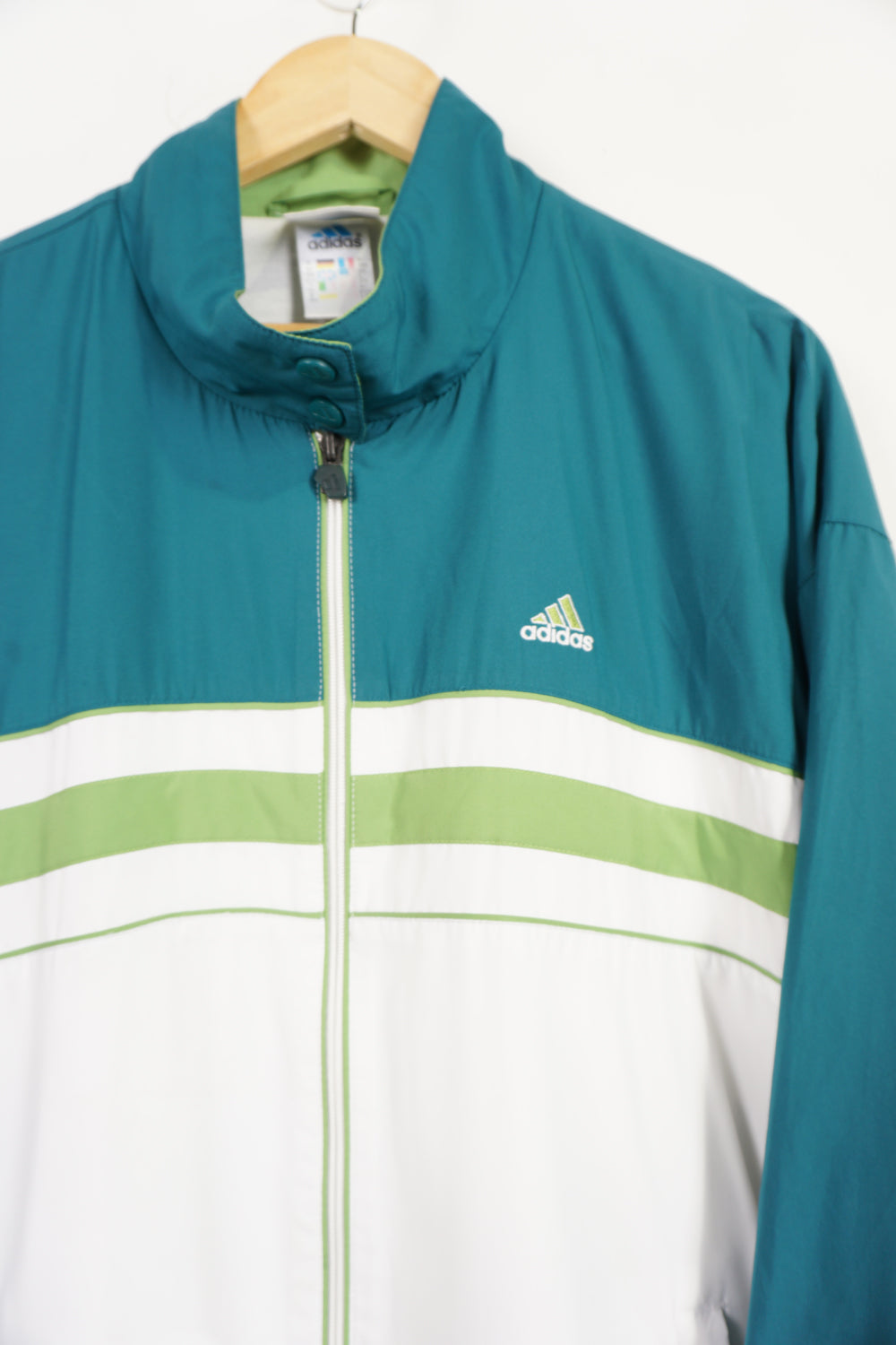 90's Teal Adidas zip through tracksuit top with green details and embroidered logo on the chest. "Tennis Club Sommerbostel" raised lettering on&nbsp;reverse good condition: slight discolouration on lettering Size in Label: L 