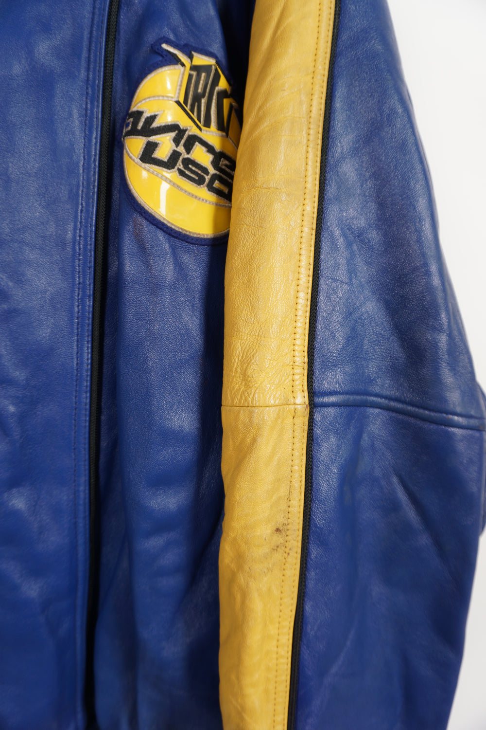 Vintage Avirex USA Slam Dunk 05 blue and yellow leather varsity jacket with embroidered patches on the front and back 