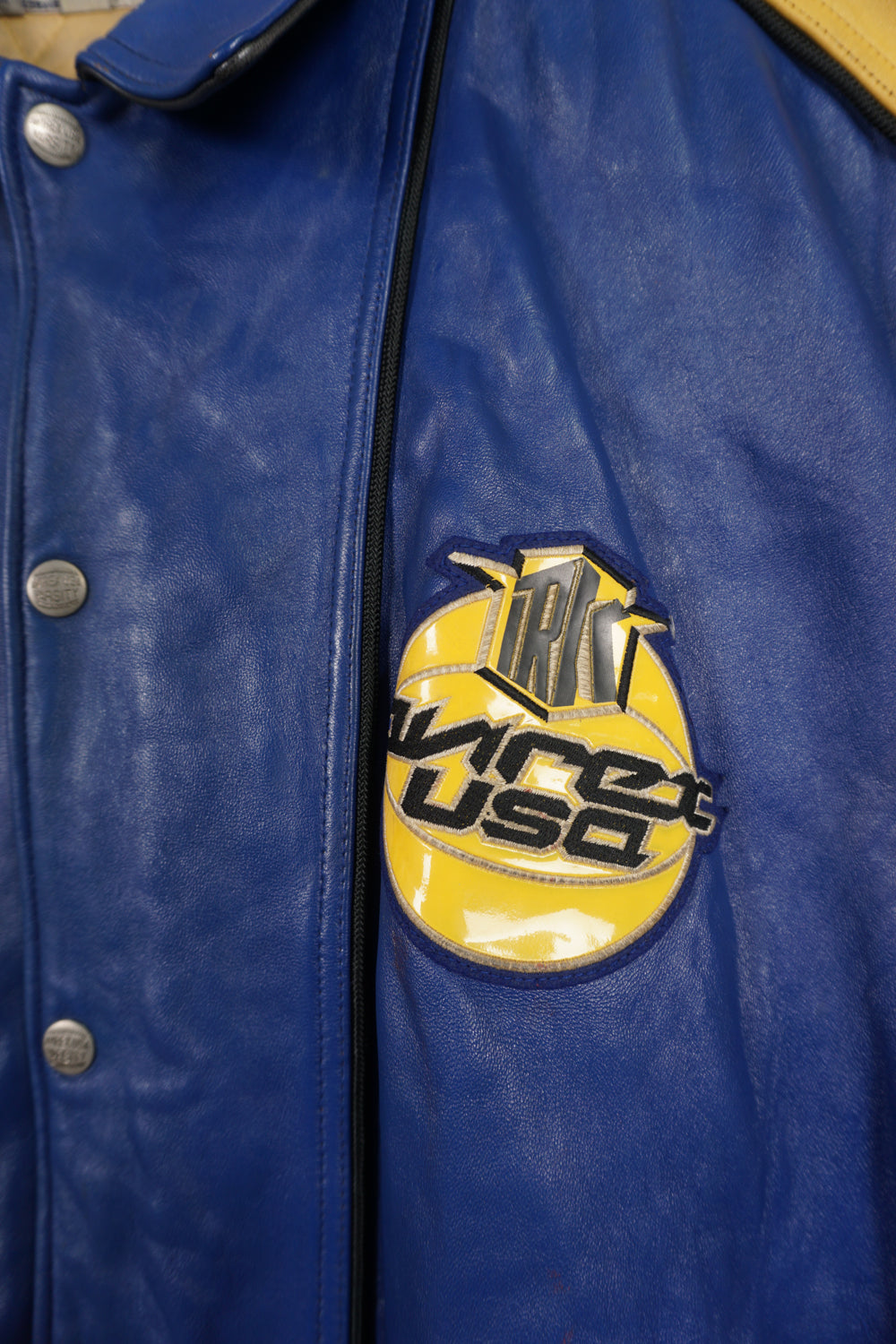 Vintage Avirex USA Slam Dunk 05 blue and yellow leather varsity jacket with embroidered patches on the front and back 