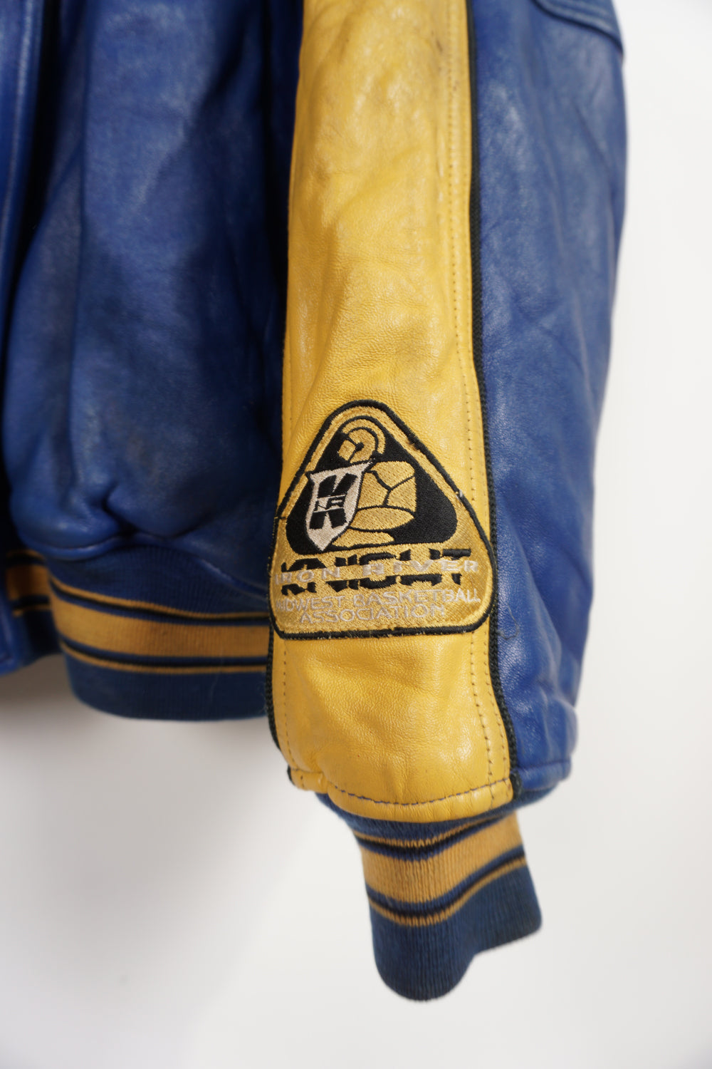 Vintage Avirex USA Slam Dunk 05 blue and yellow leather varsity jacket with embroidered patches on the front and back 