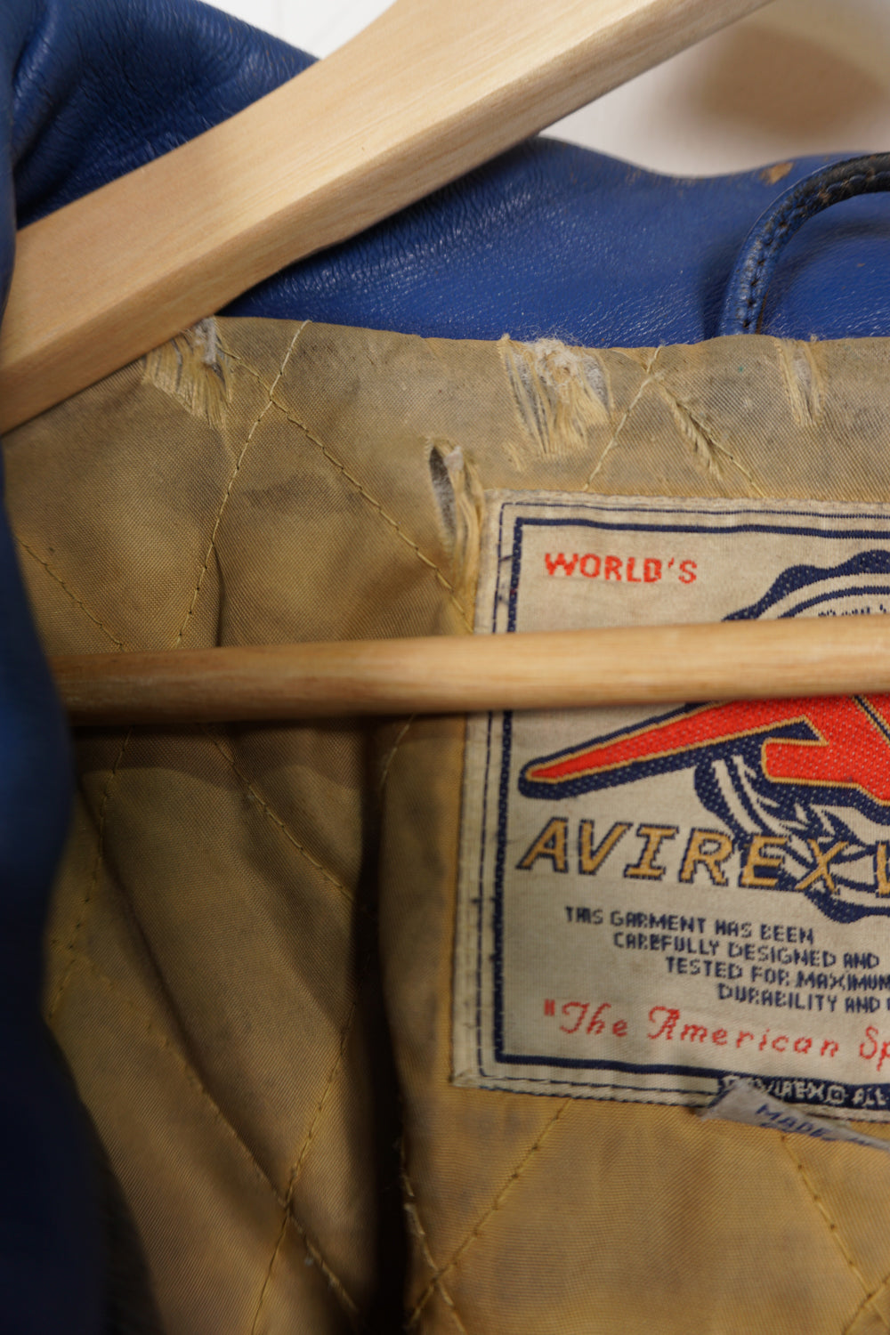 Vintage Avirex USA Slam Dunk 05 blue and yellow leather varsity jacket with embroidered patches on the front and back 