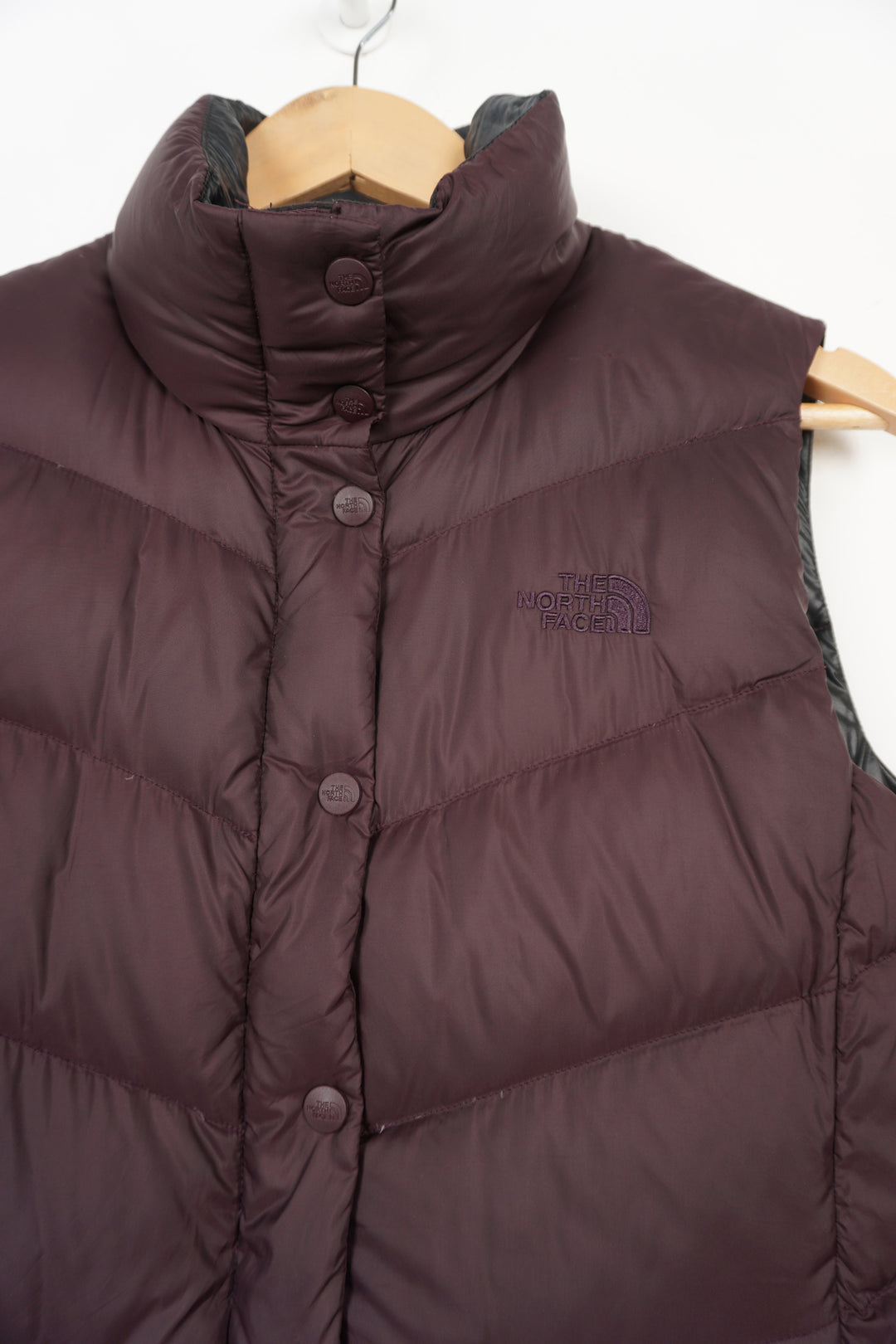 The North Face 700 purple zip through gilet with embroidered logo on the chest