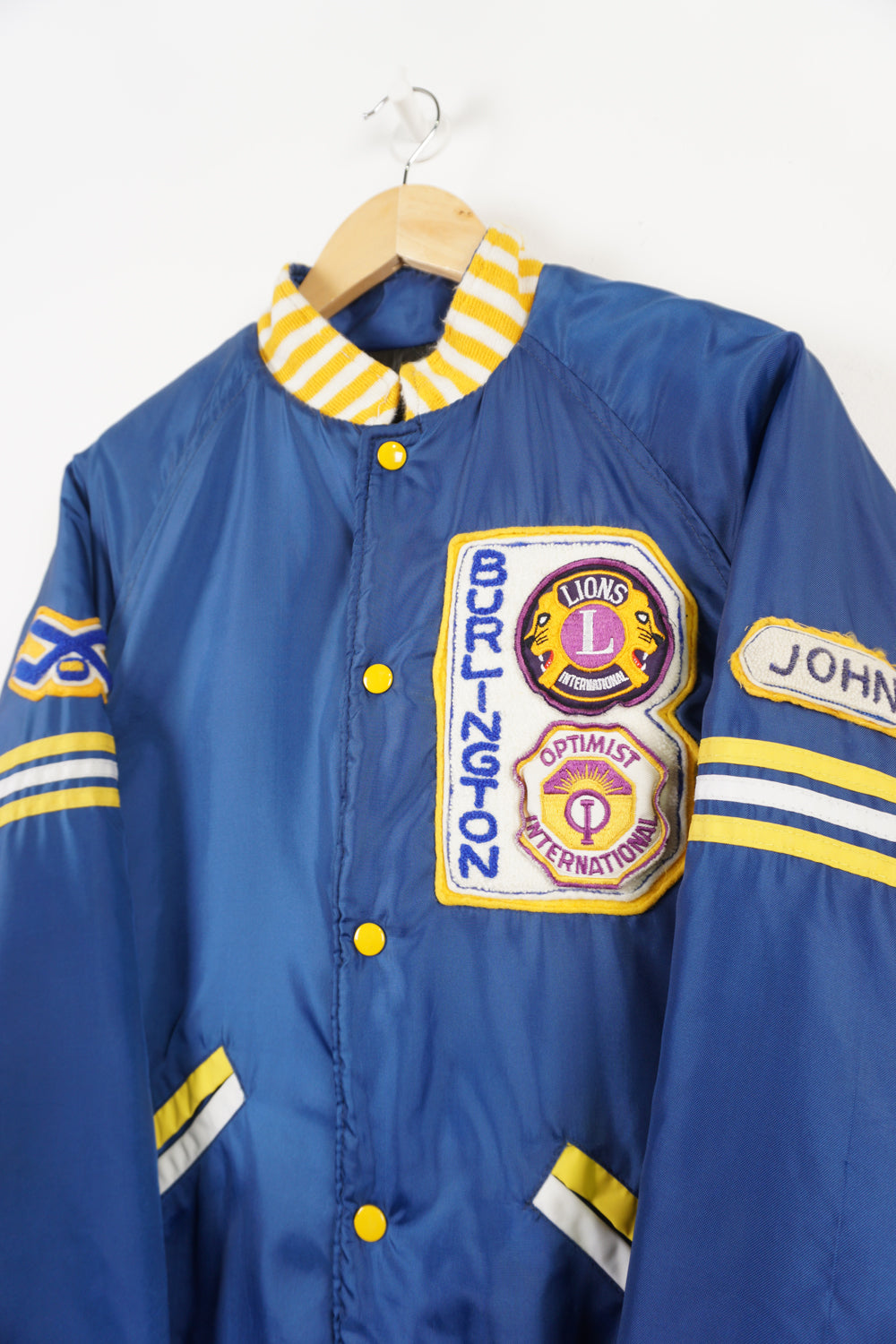 Vintage 1970s/80s blue bomber jacket with embroidered Burlington badges and quilted lining