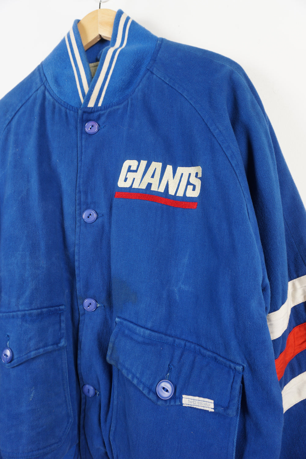 Vintage 1995 New York Giants cotton bomber Jacket. Embroidered name on front and logo on back. Fair Condition, signs of wear due to age, discolouring on team name and dark mark near front pockets (see pictures) Size in Label: L 