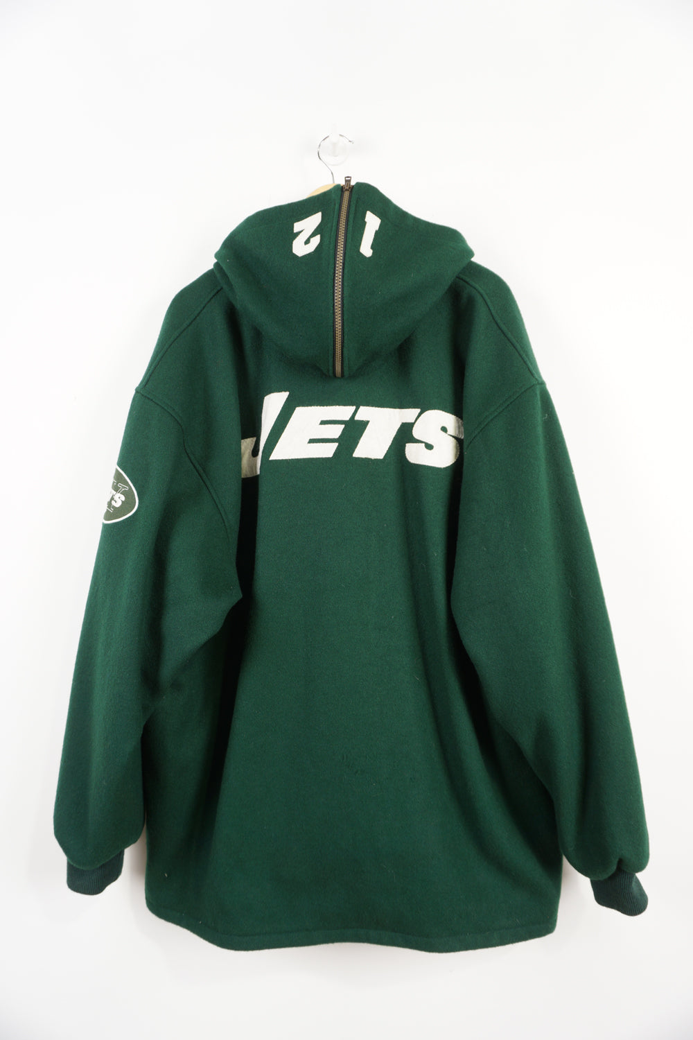 Vintage 90's New York Jets green hooded varsity jacket, reversible. Embroidered logo and name on front, back and sleeve. Good Condition, 2 small holes on back of right sleeve (see pictures) Size in Label: XL