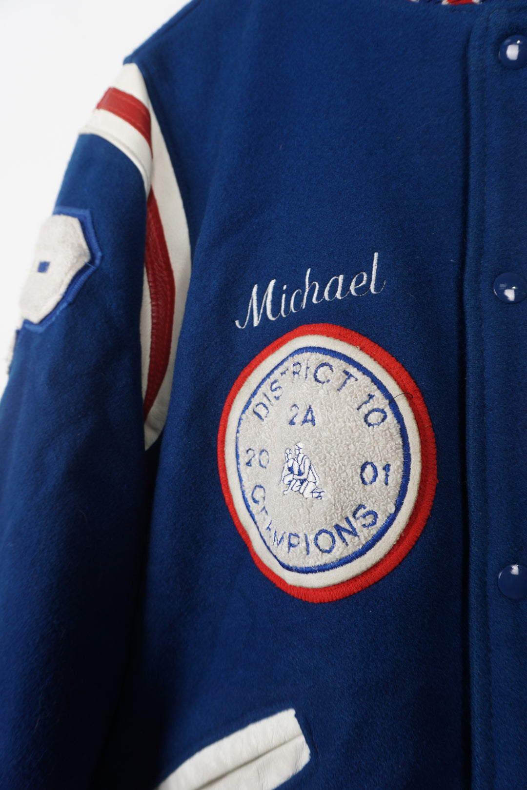 Vintage Patriots Wrestling wool varsity jacket in blue. Features embroidered details and wrestling themed pins 