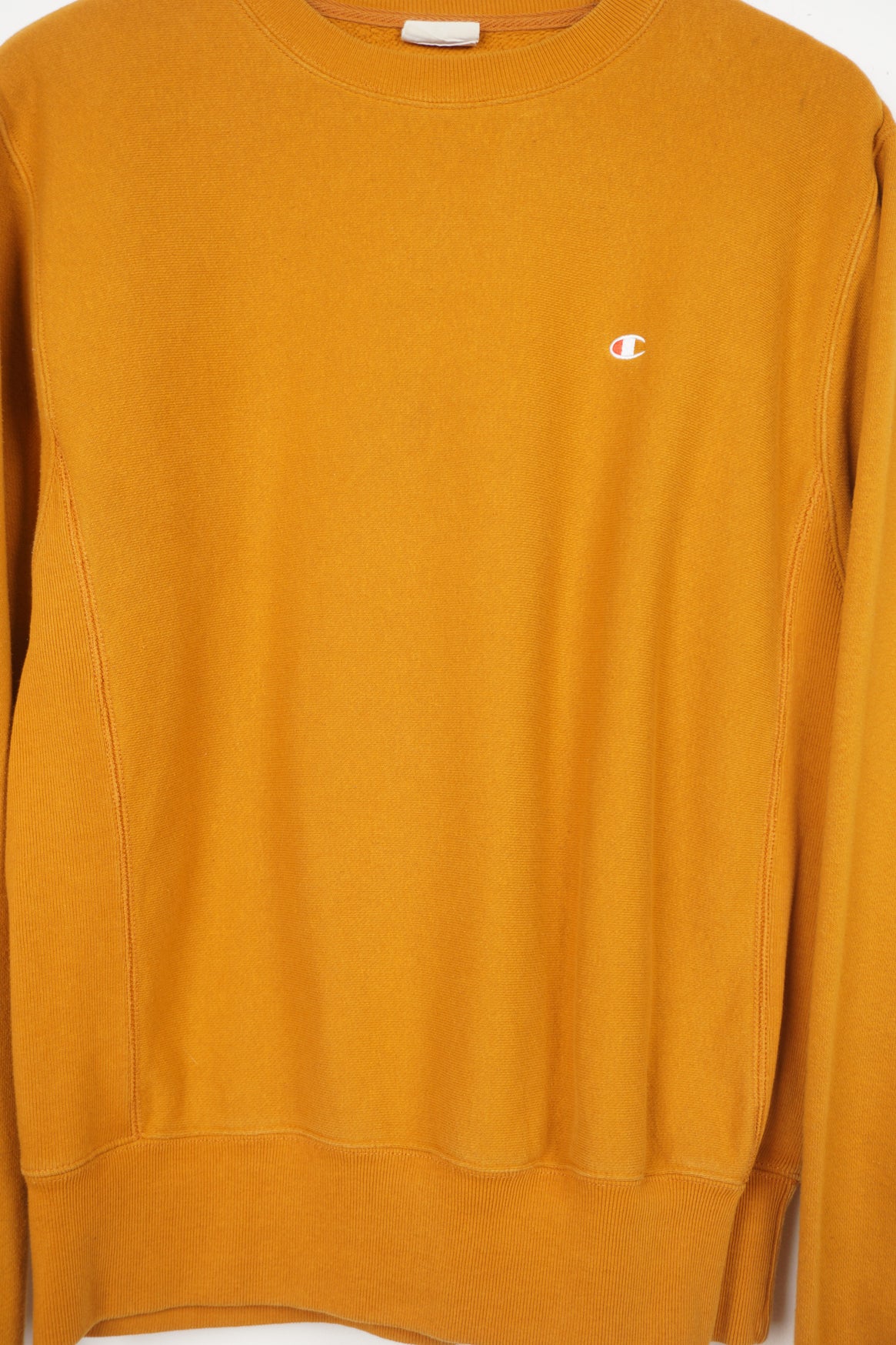 Mustard yellow crew neck Champion sweatshirt with small logo on the chest