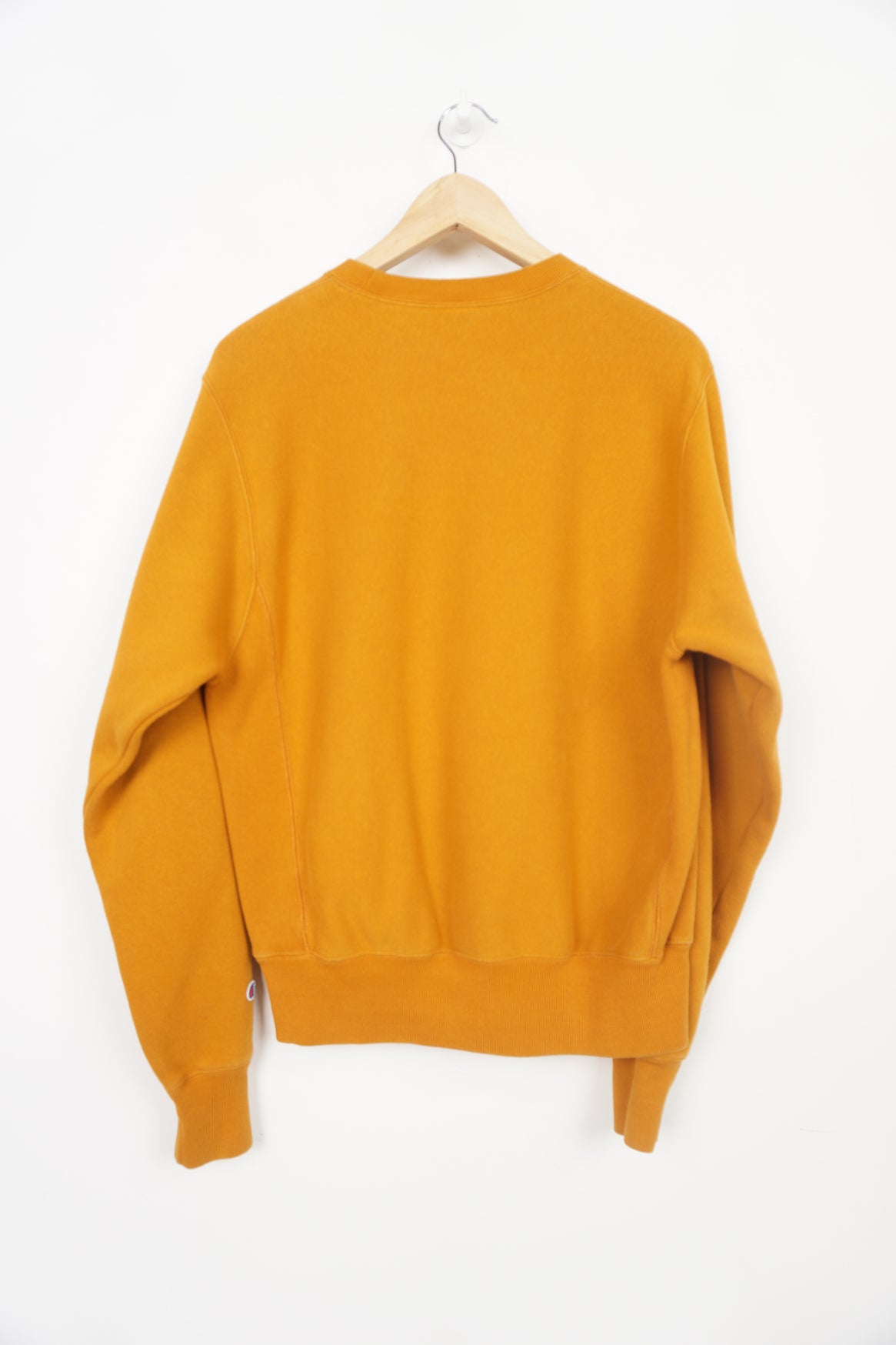 Mustard yellow crew neck Champion sweatshirt with small logo on the chest