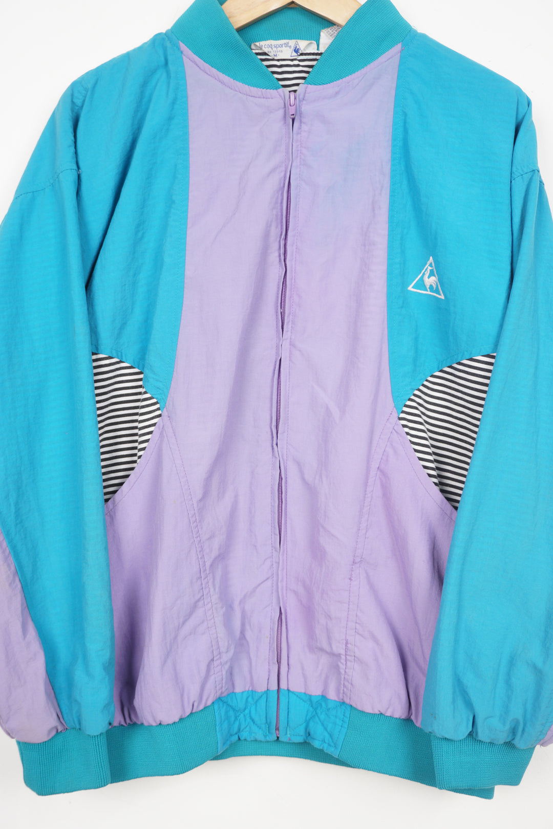 Vintage 1980's Le Coq Sportif turquoise and purple shell jacket with embroidered logo on the chest 