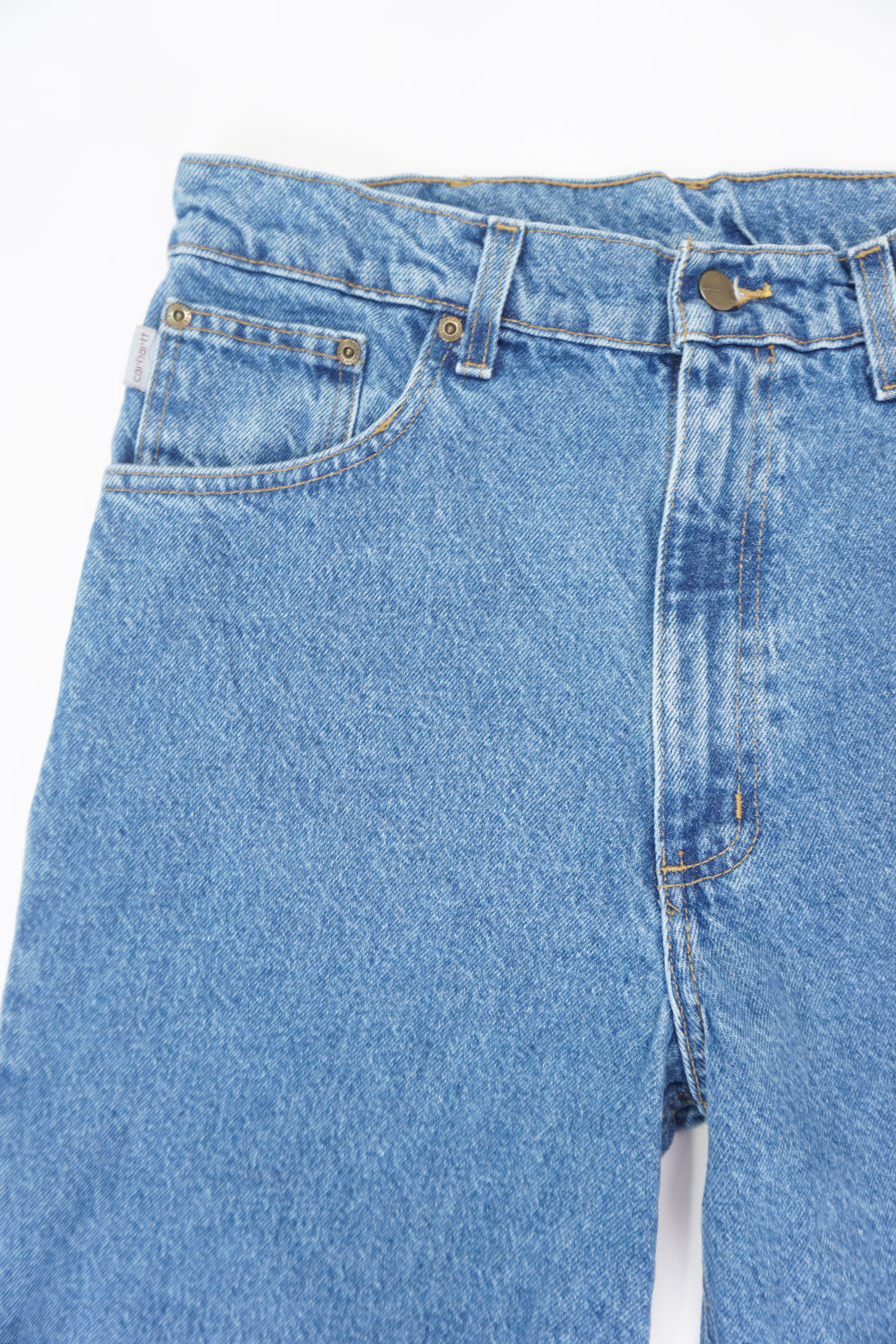 Carhartt traditional fit blue denim jeans with signature leather logo on the back pocket