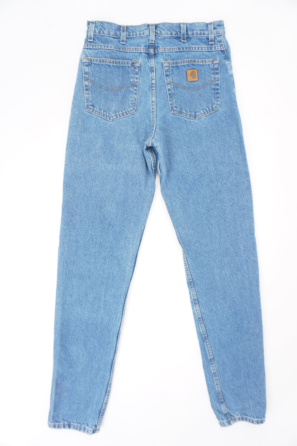 Carhartt traditional fit blue denim jeans with signature leather logo on the back pocket