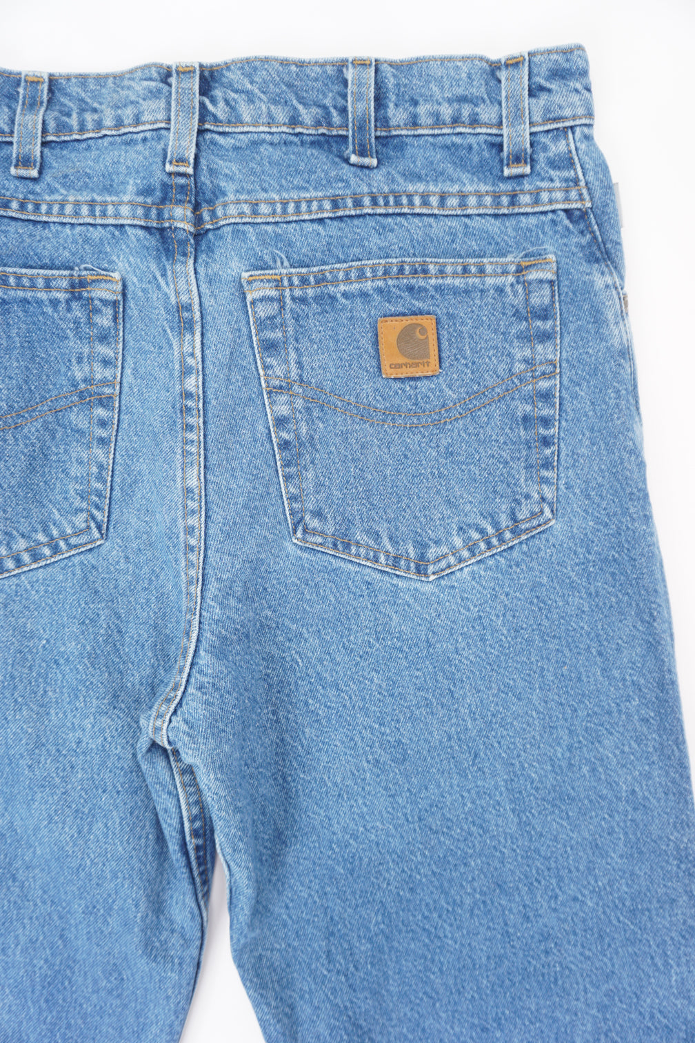 Carhartt traditional fit blue denim jeans with signature leather logo on the back pocket