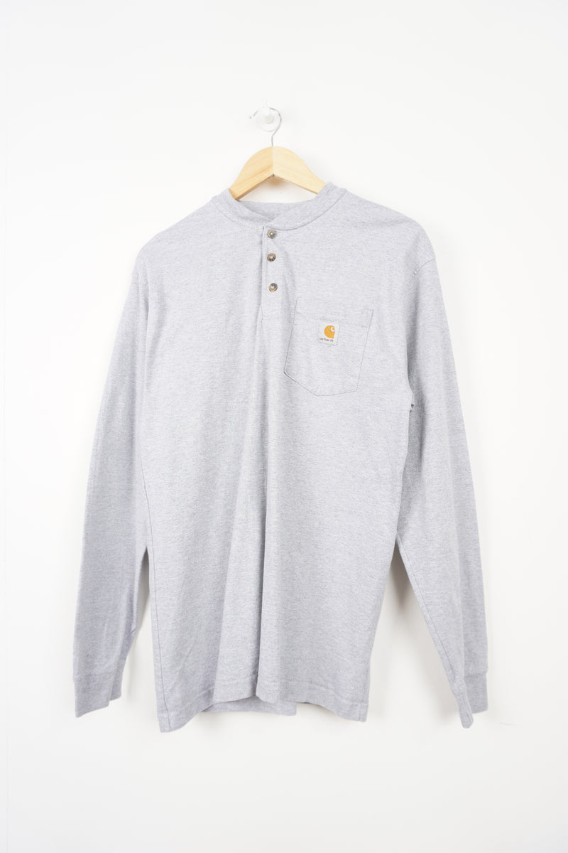 Grey long sleeve Carhartt t-shirt with branded chest pocket and button up details 