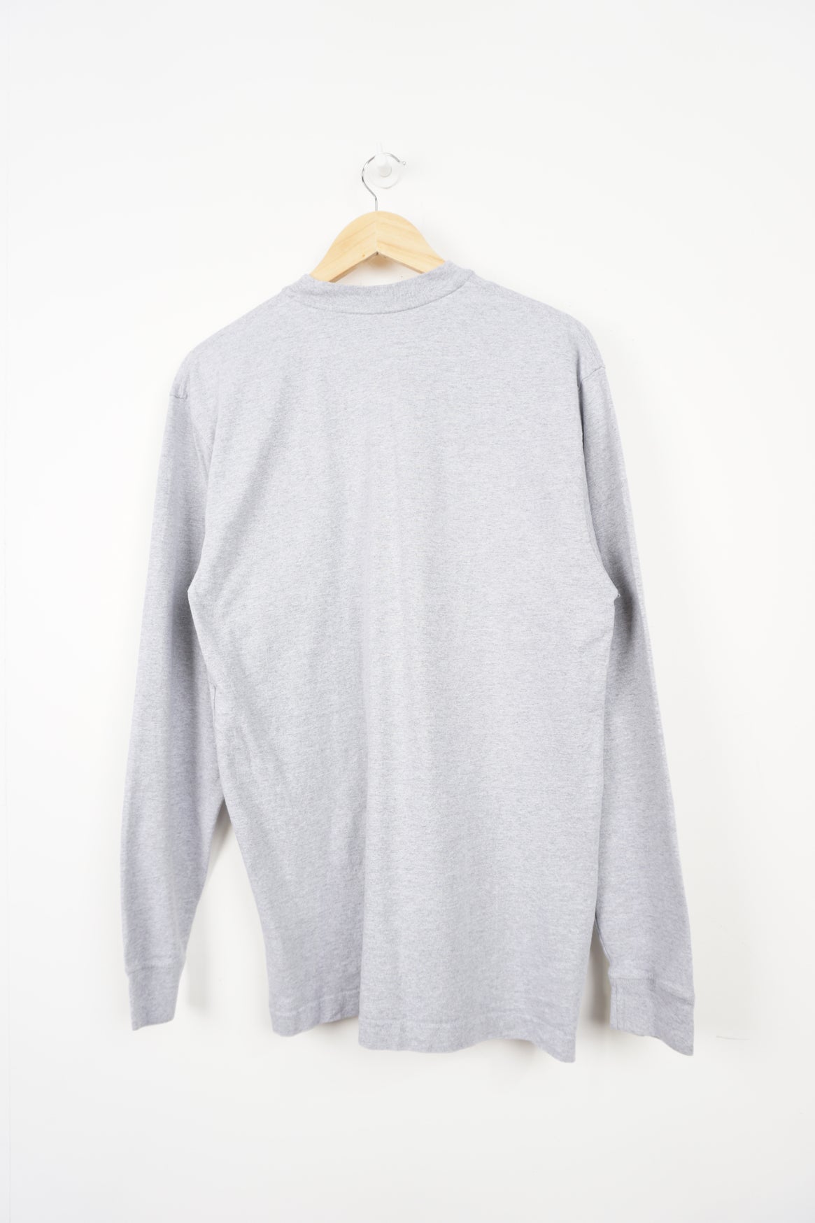 Grey long sleeve Carhartt t-shirt with branded chest pocket and button up details 