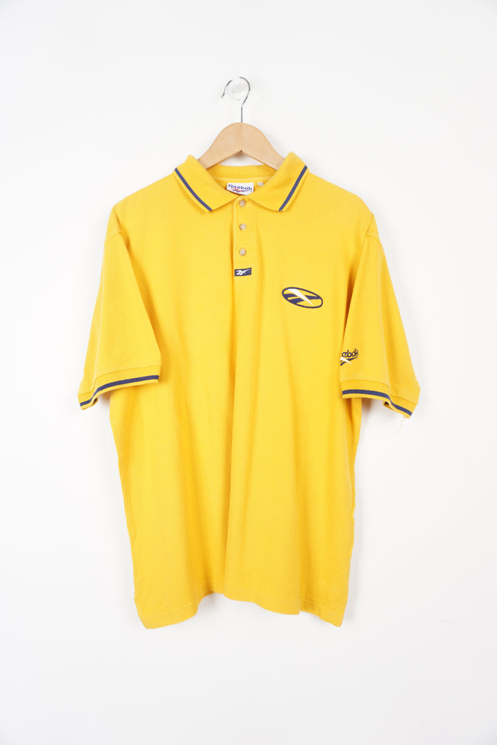 90's Reebok all yellow polo shirt with embroidered logo on the chest