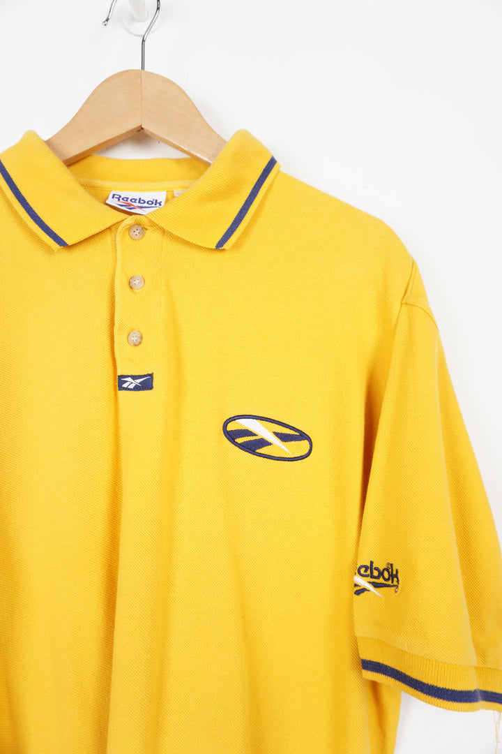 90's Reebok all yellow polo shirt with embroidered logo on the chest