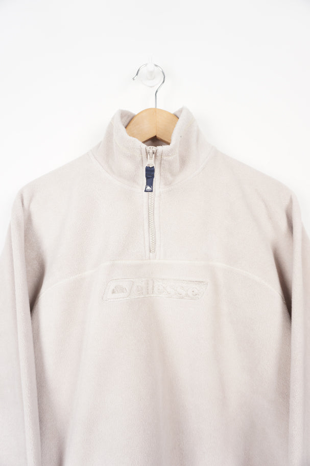 Cream Ellesse 1/4 zip fleece with embroidered logo on the chest