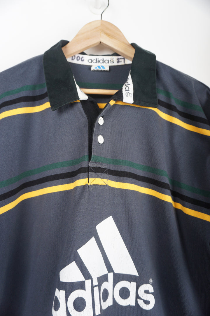 Vintage Adidas Grey Polo Shirt with green/black/yellow stripes and logo on chest Item in good condition, print cracking on chest logo Size in Label: XXL