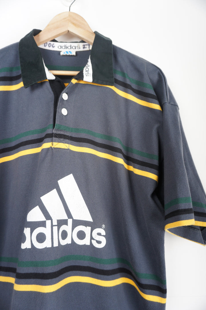 Vintage Adidas Grey Polo Shirt with green/black/yellow stripes and logo on chest Item in good condition, print cracking on chest logo Size in Label: XXL