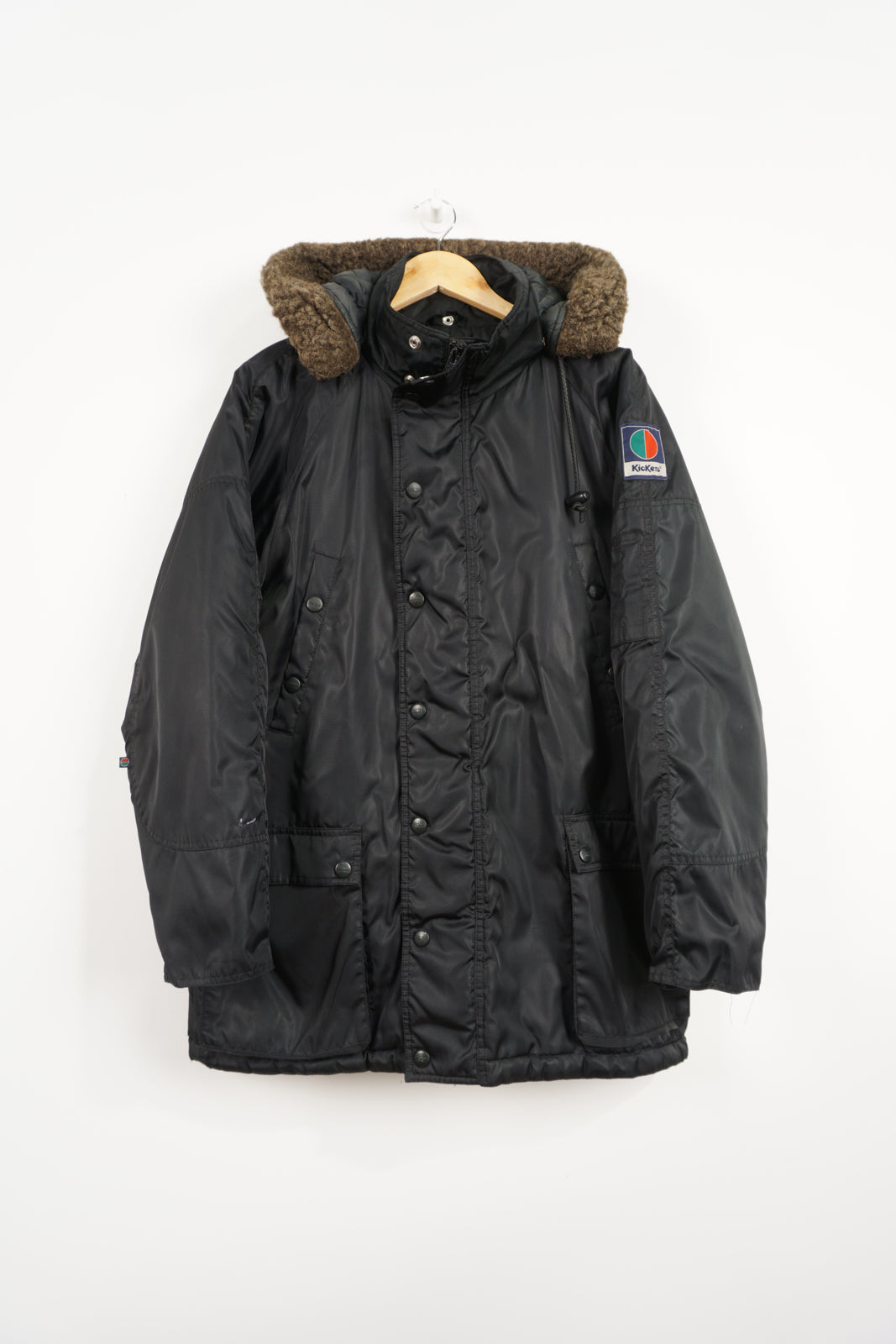 All black Kickers winter coat with detachable hood and embroidered logo on the sleeve