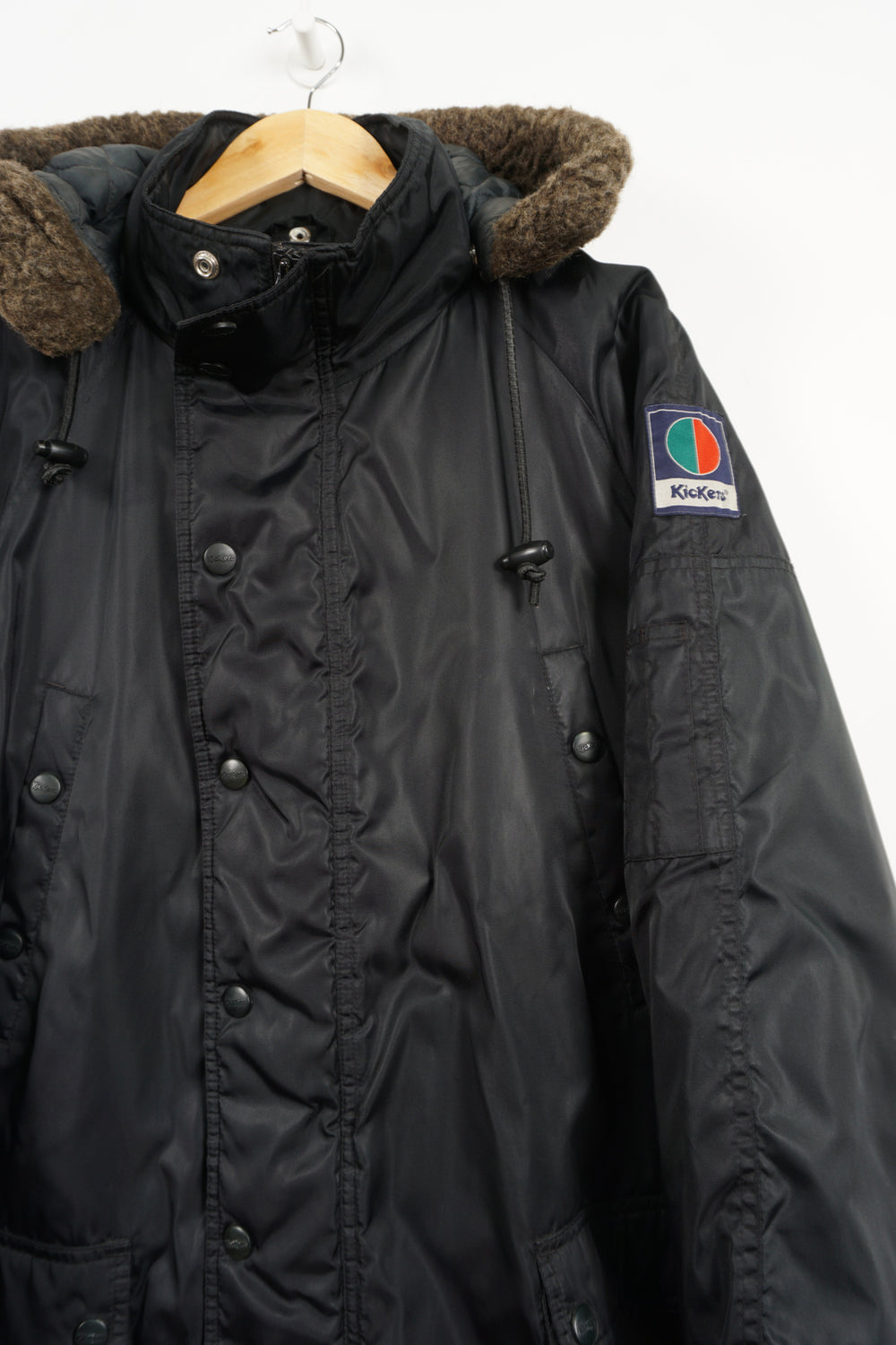 All black Kickers winter coat with detachable hood and embroidered logo on the sleeve