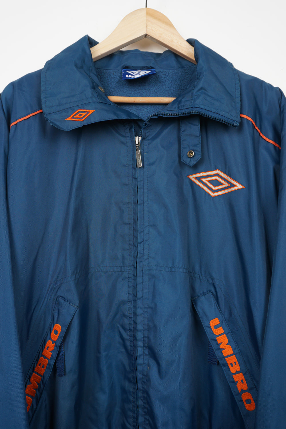 Vintage blue zip through Umbro coat with embroidered logo on the chest and foldaway hood 