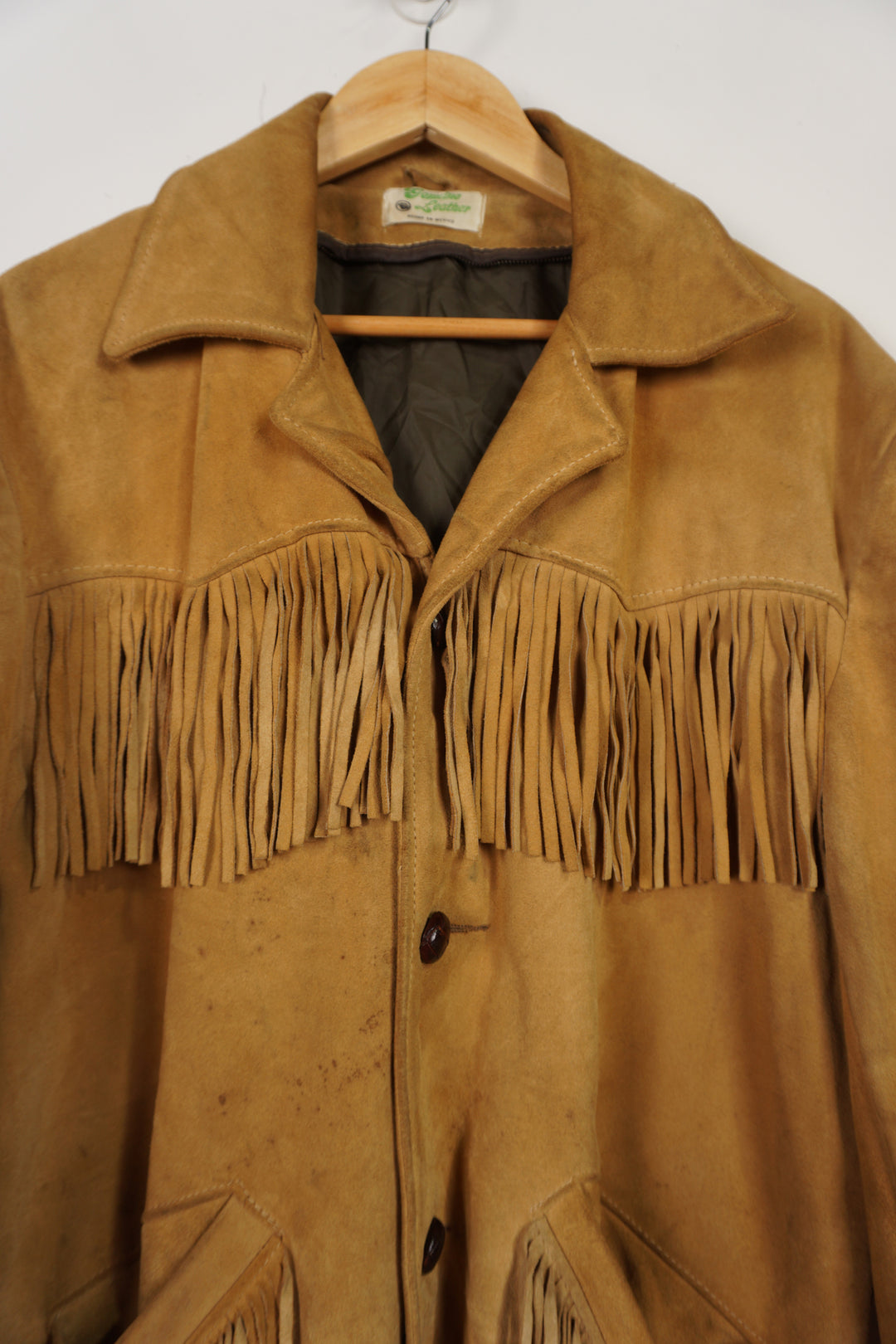 Vintage made in Mexico tan suede leather jacket with fringe details on the front and down both sleeves