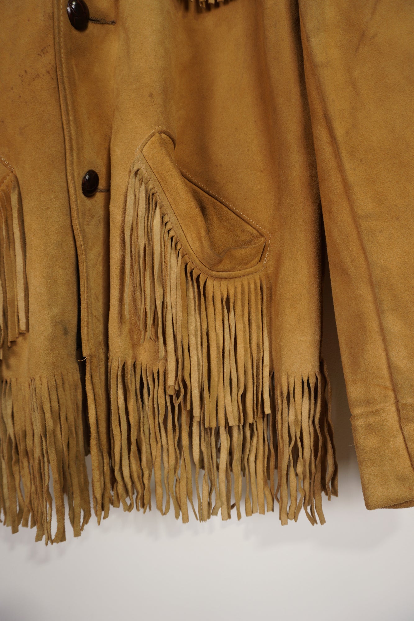 Vintage made in Mexico tan suede leather jacket with fringe details on the front and down both sleeves