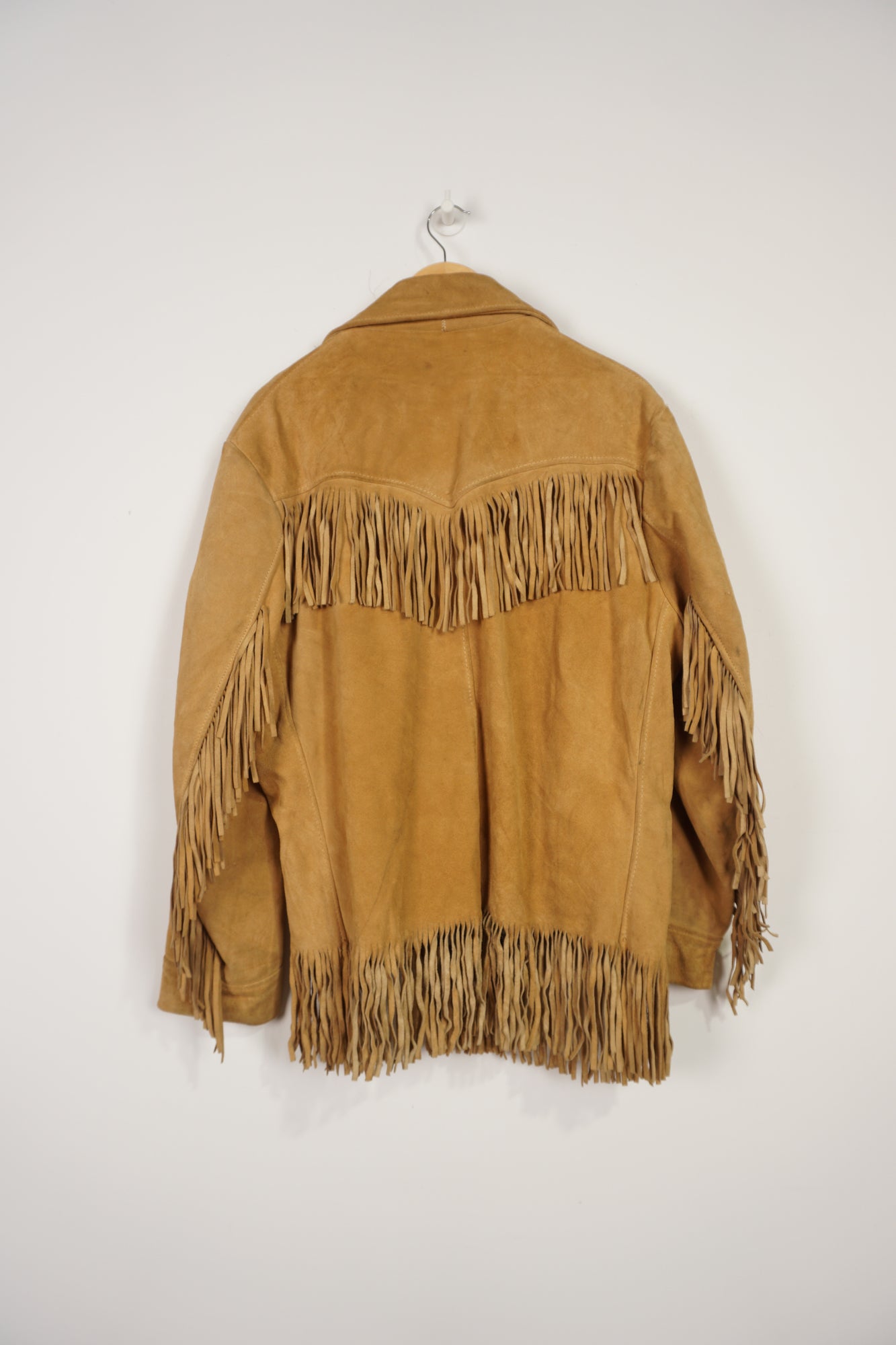 Vintage made in Mexico tan suede leather jacket with fringe details on the front and down both sleeves