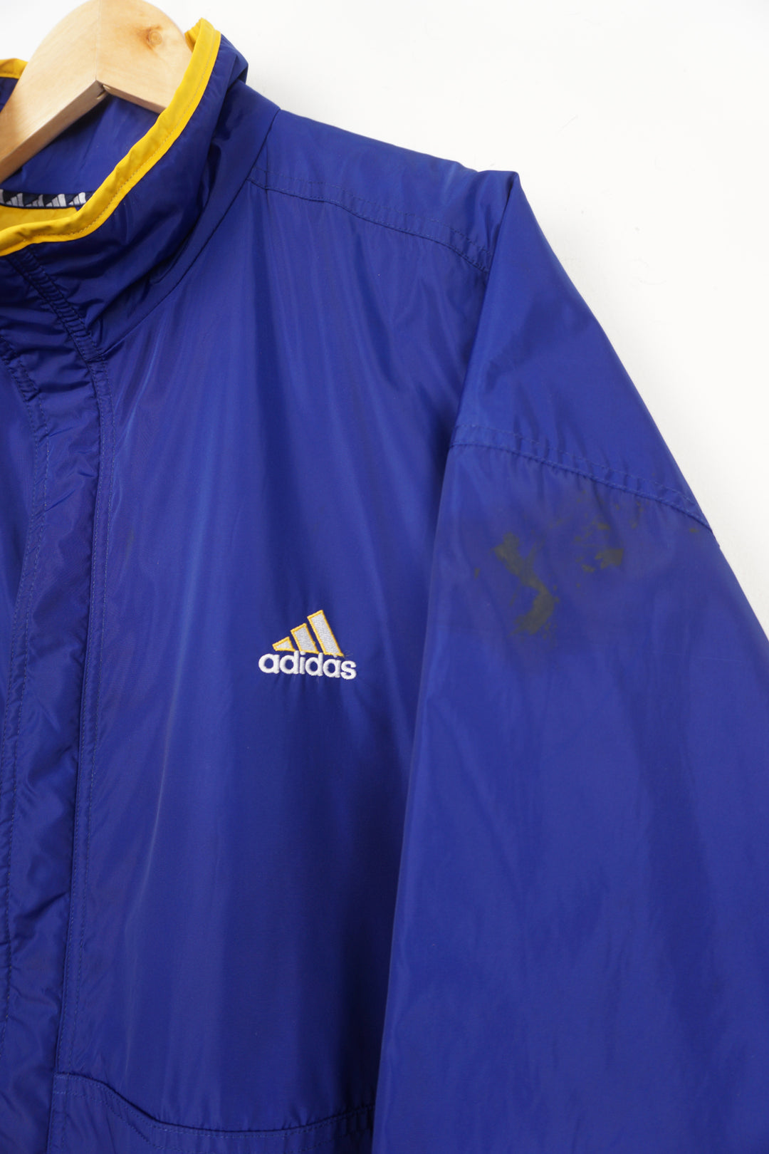 Vintage 90's blue Adidas coat with yellow quilted lining, embroidered logo on the chest and zip up pockets