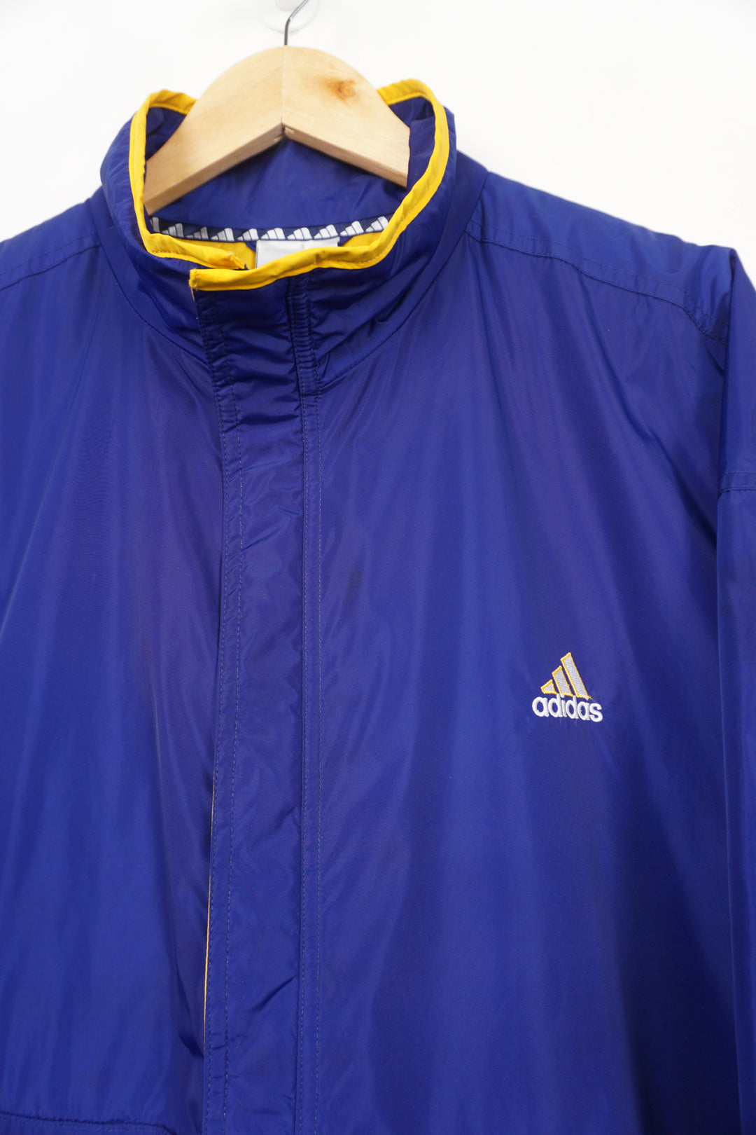 Vintage 90's blue Adidas coat with yellow quilted lining, embroidered logo on the chest and zip up pockets