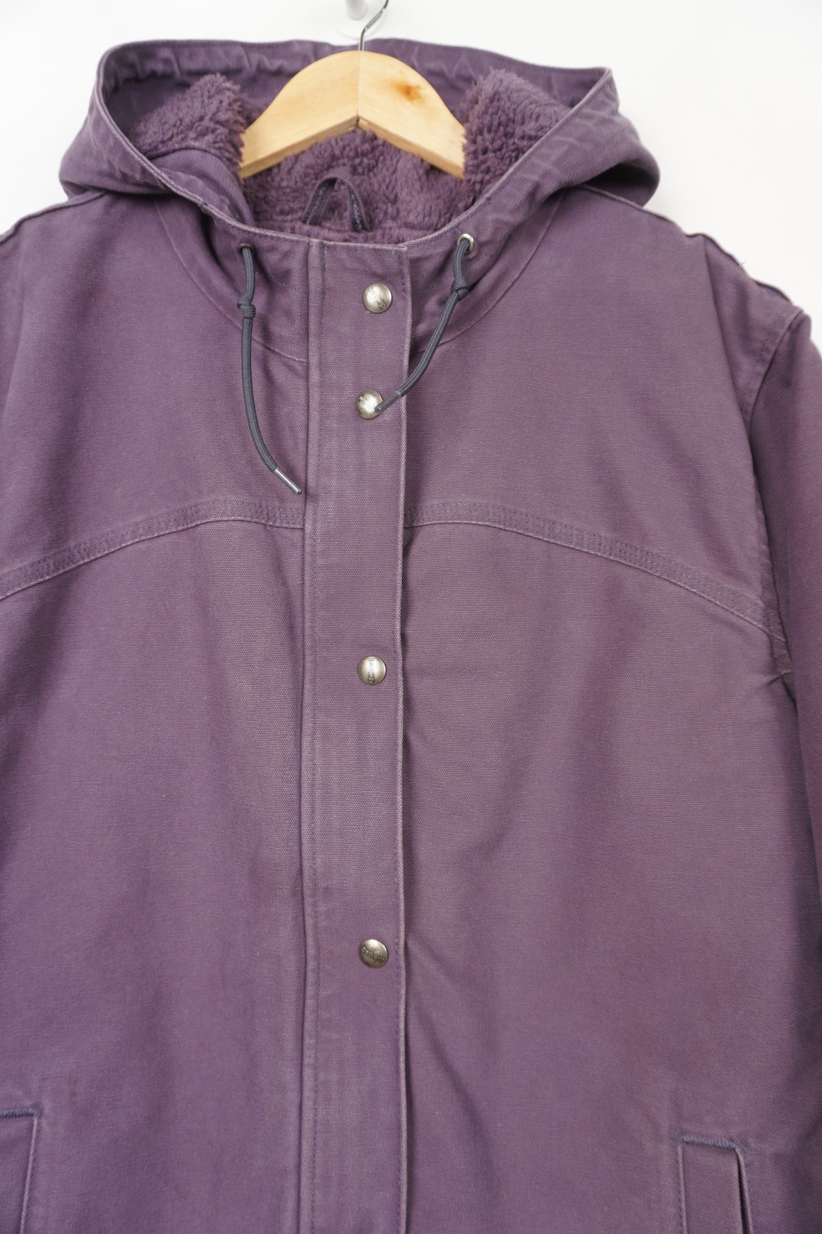 Purple heavy duty cotton hooded Carhartt jacket with embroidered logo on the pocket and fleece lining