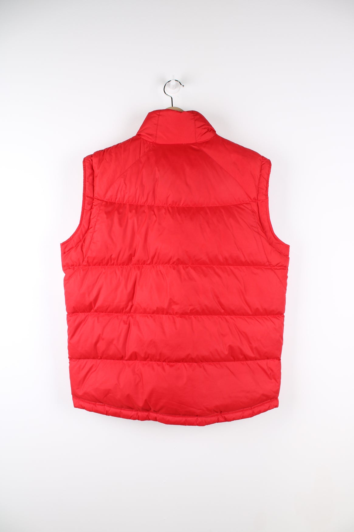 Red Nike zip through puffer gilet. Features embroidered logo on the chest.