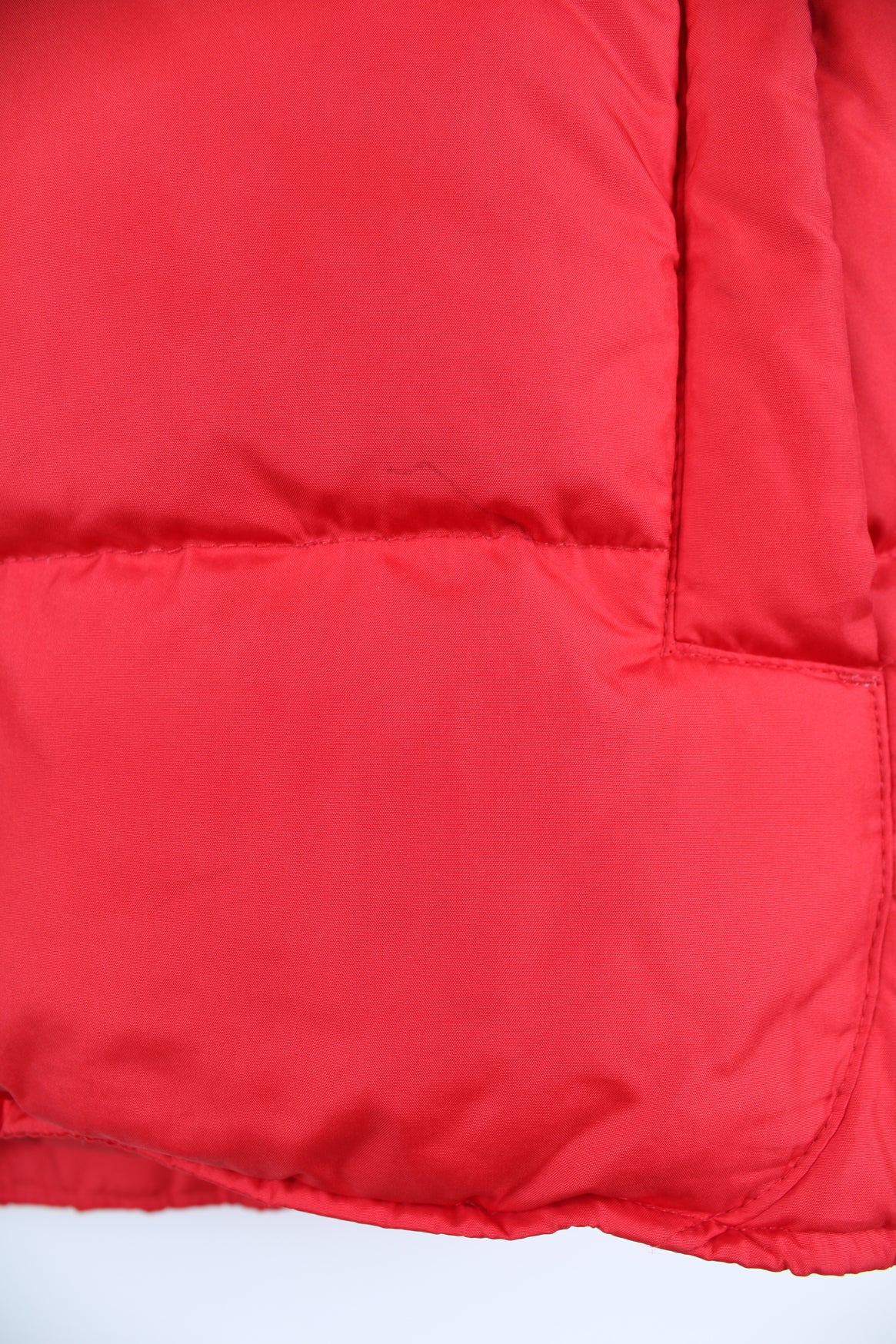 Red Nike zip through puffer gilet. Features embroidered logo on the chest.