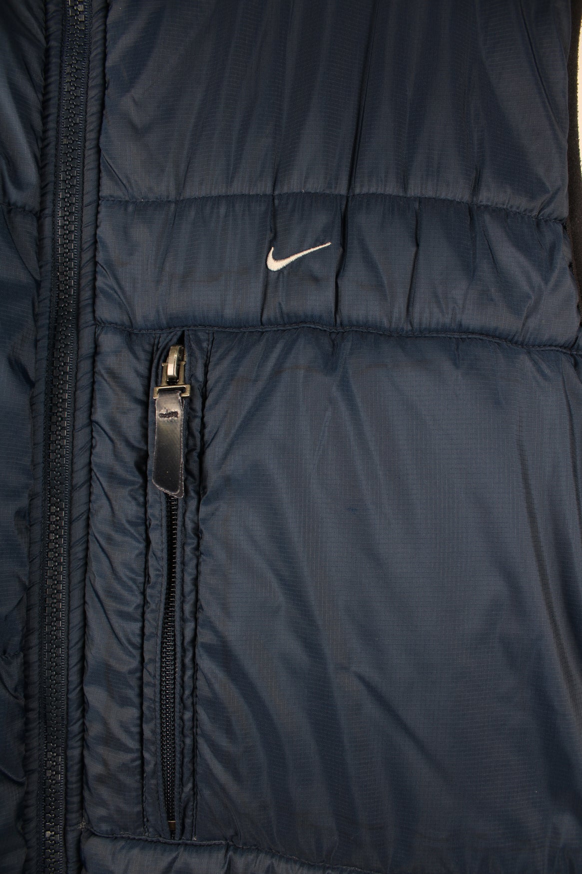 Vintage Nike reversible light puffer vest in blue and grey.