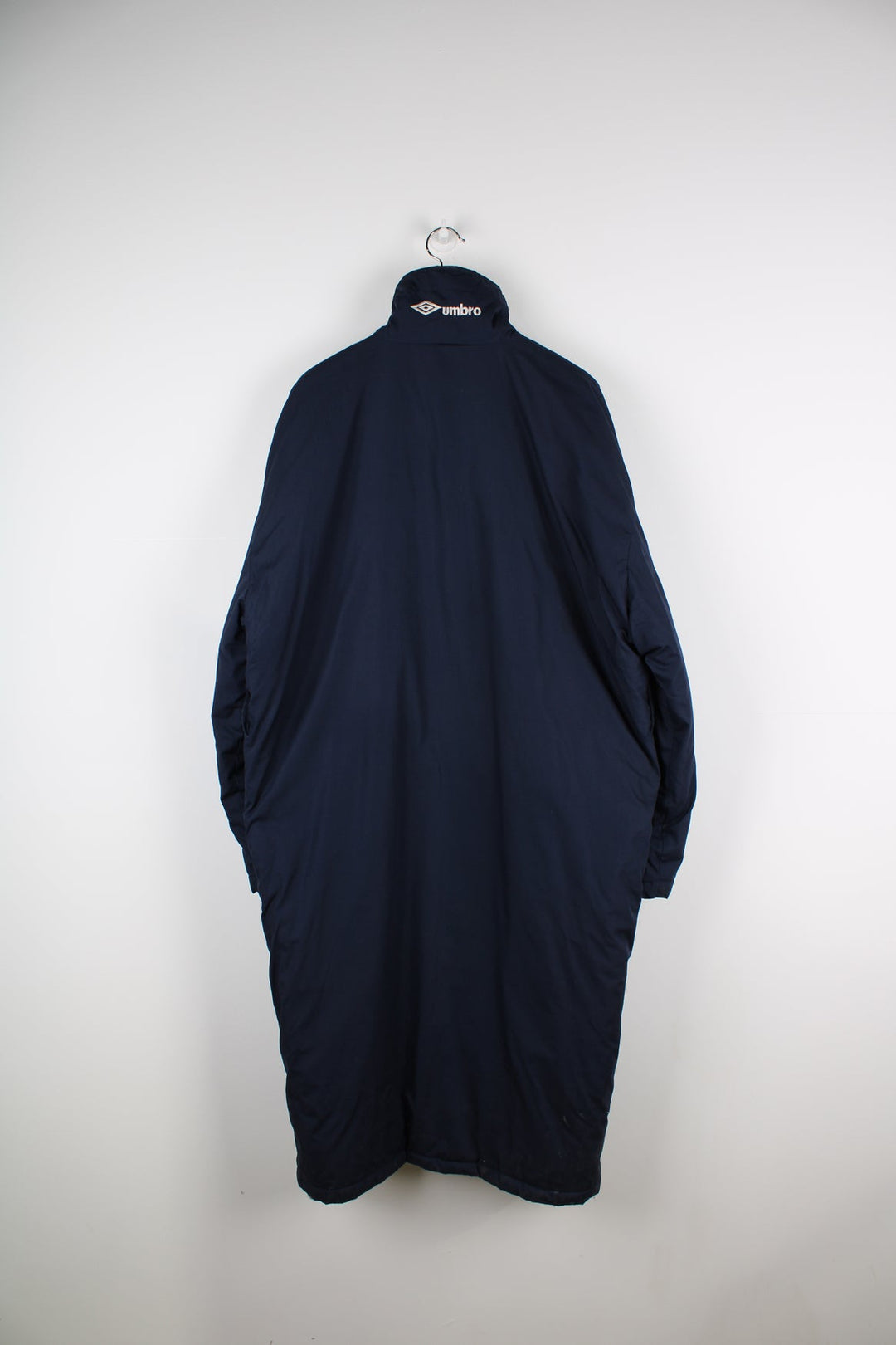 Blue Umbro maxi longline coat. Features pockets on the chest and embroidered logo on the neck.