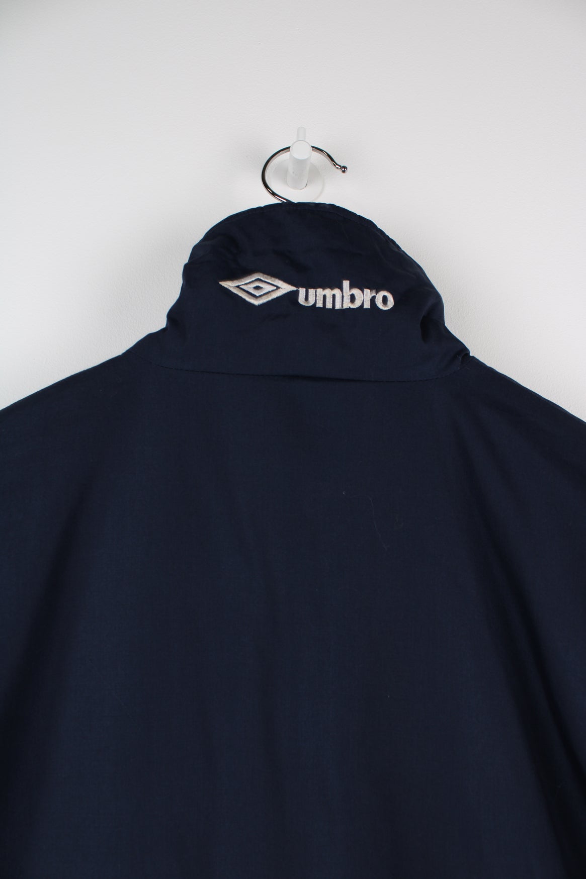 Blue Umbro maxi longline coat. Features pockets on the chest and embroidered logo on the neck.