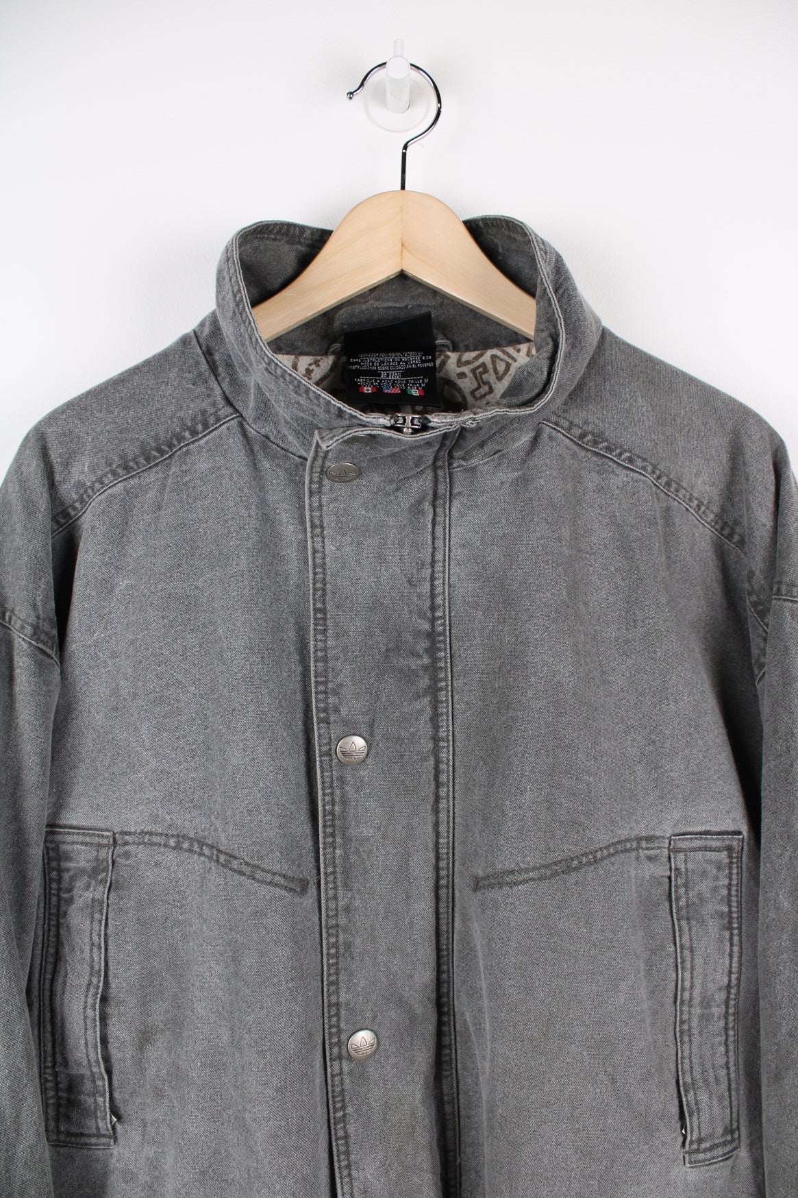 Adidas grey stonewash denim coat. Features embroidered logo on lower pocket.