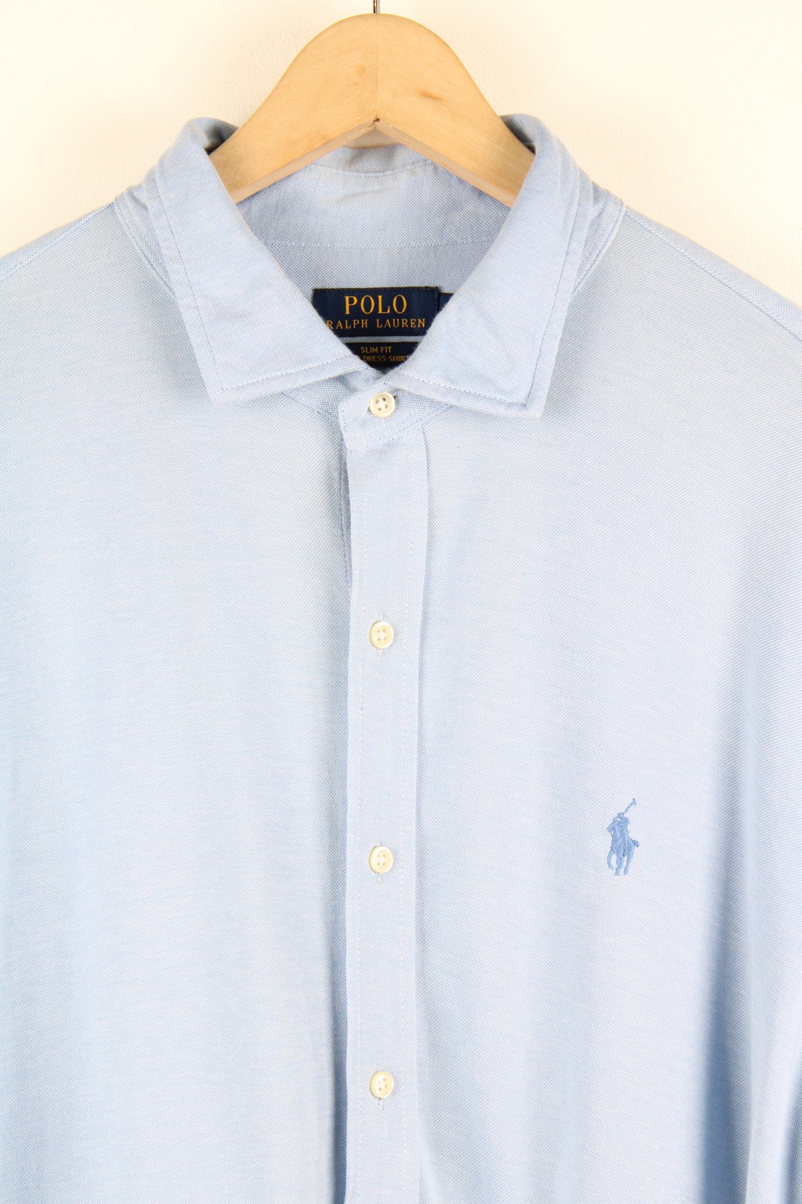 Ralph Lauren blue knit dress button up shirt with embroidered logo on the chest.