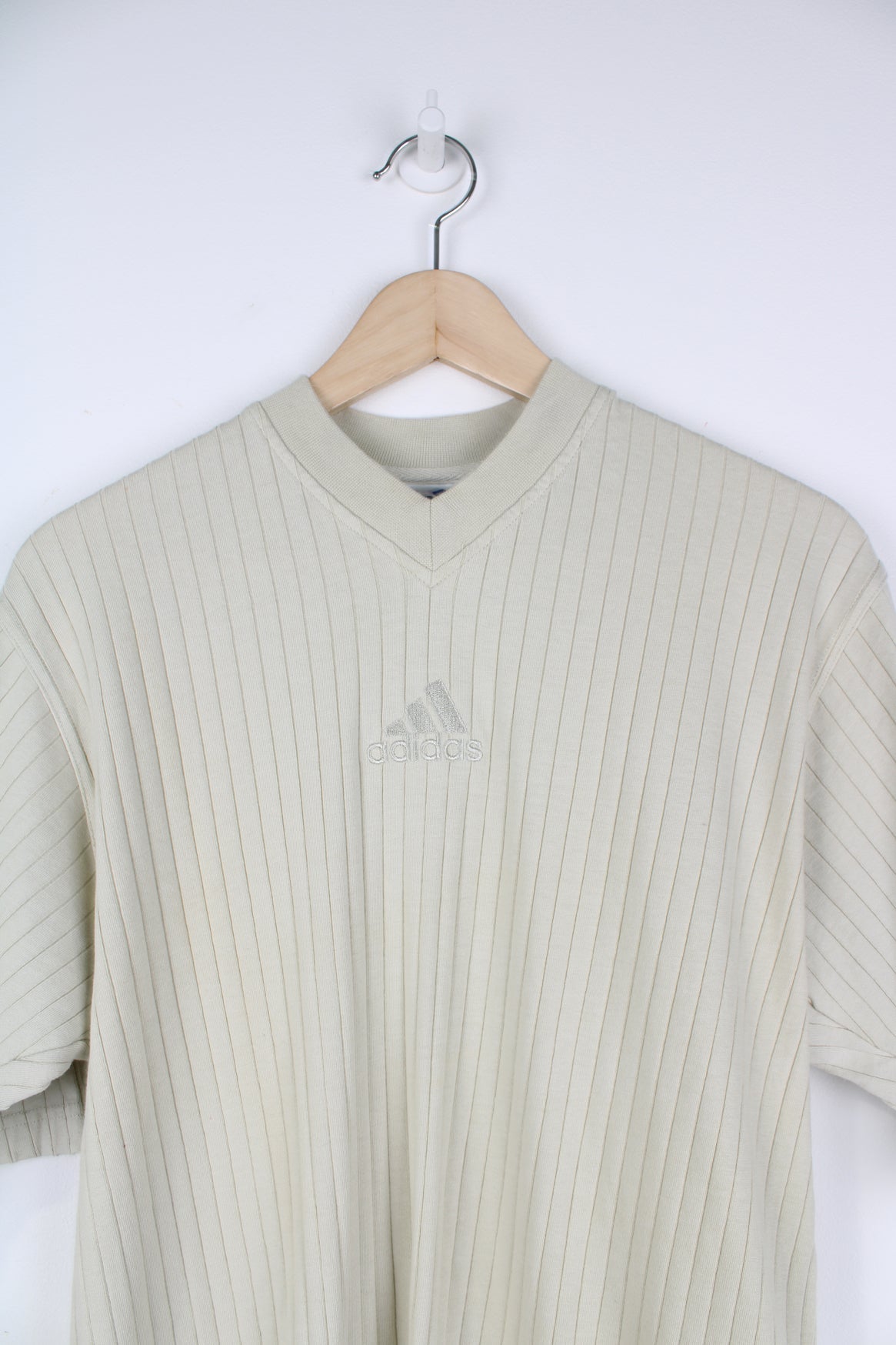 Vintage 90s Adidas v-neck ribbed T-Shirt with embroidered logo in beige.