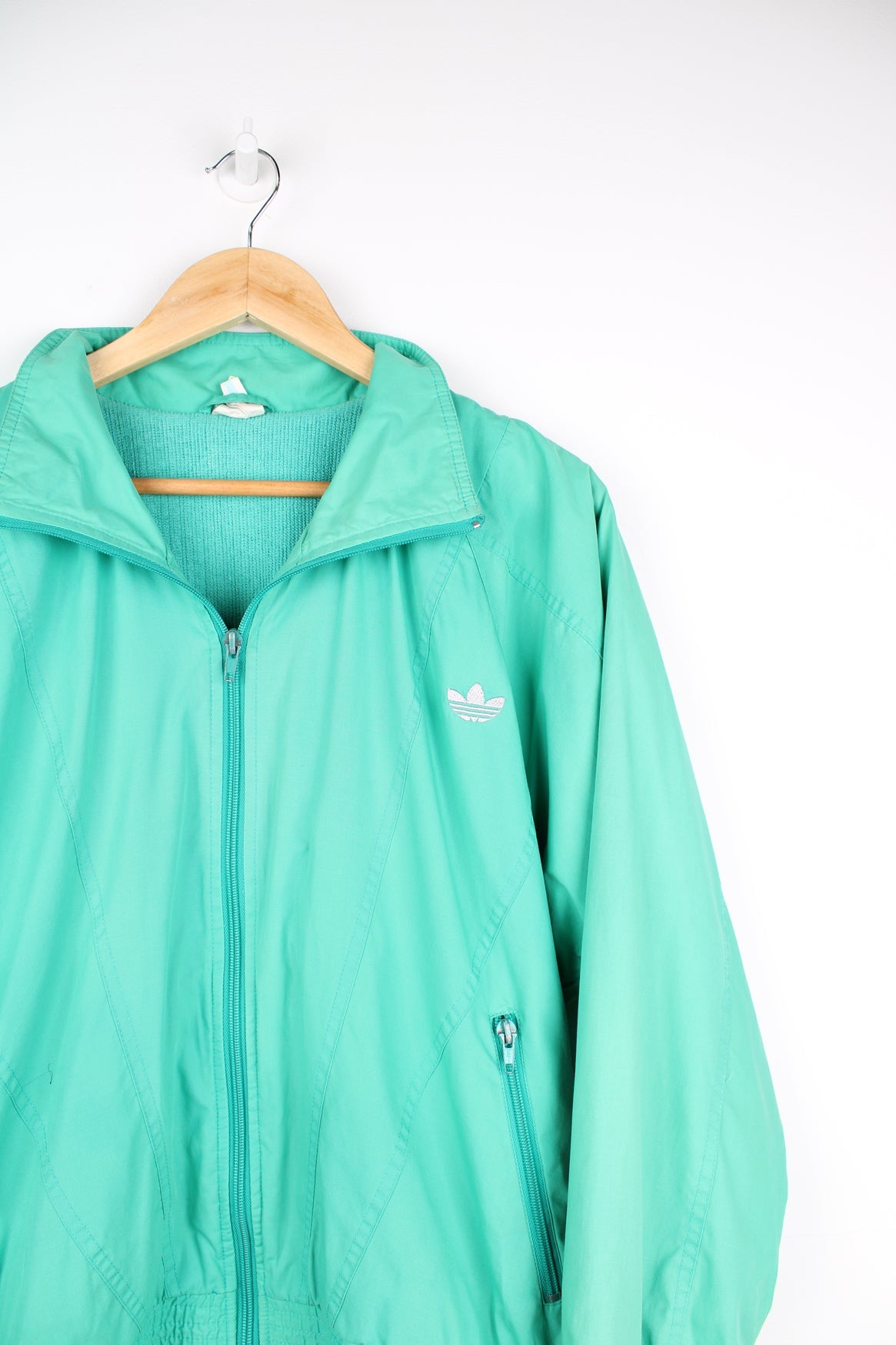 Vintage Adidas green tracksuit jacket featuring embroidered logo on the chest.