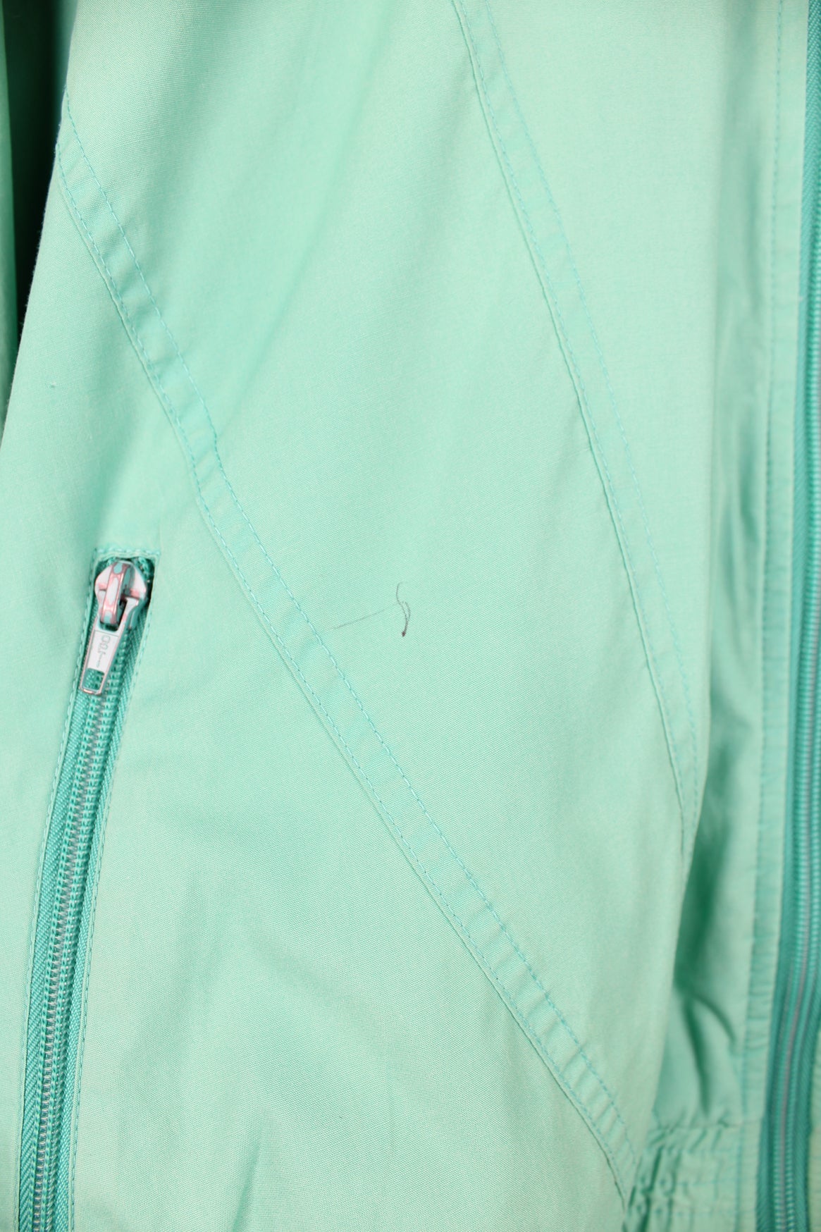 Vintage Adidas green tracksuit jacket featuring embroidered logo on the chest.