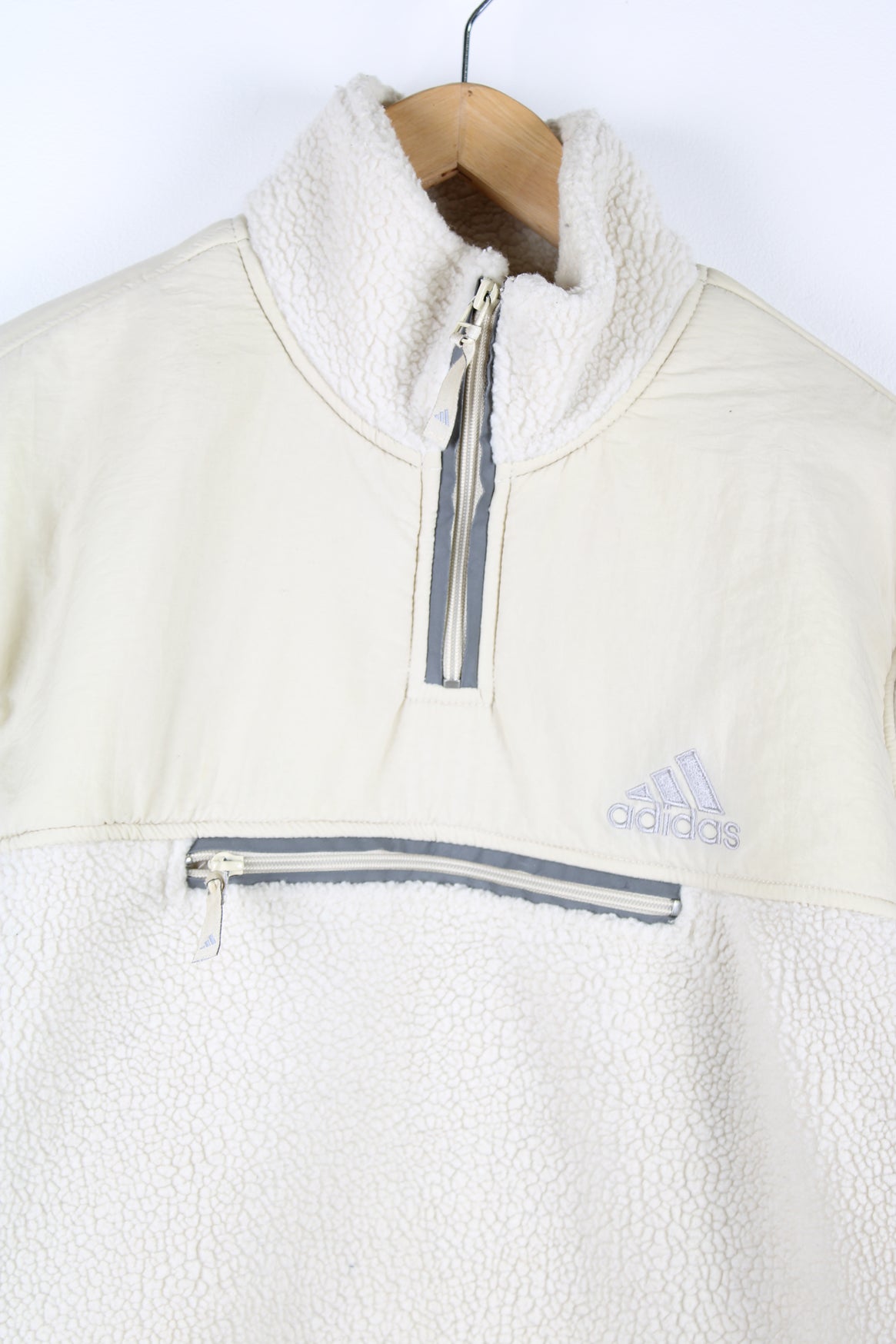 Beige Adidas pullover sherpa fleece with quarter zip and pouch pocket.