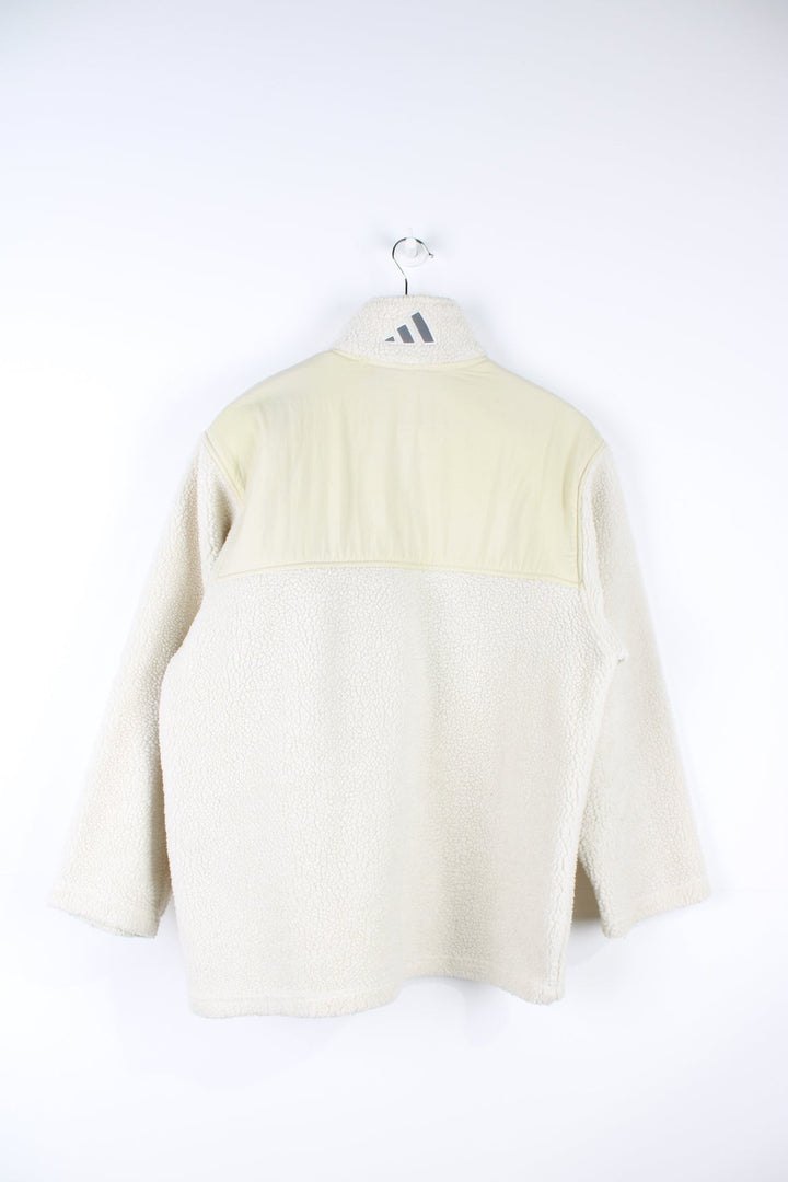 Beige Adidas pullover sherpa fleece with quarter zip and pouch pocket.