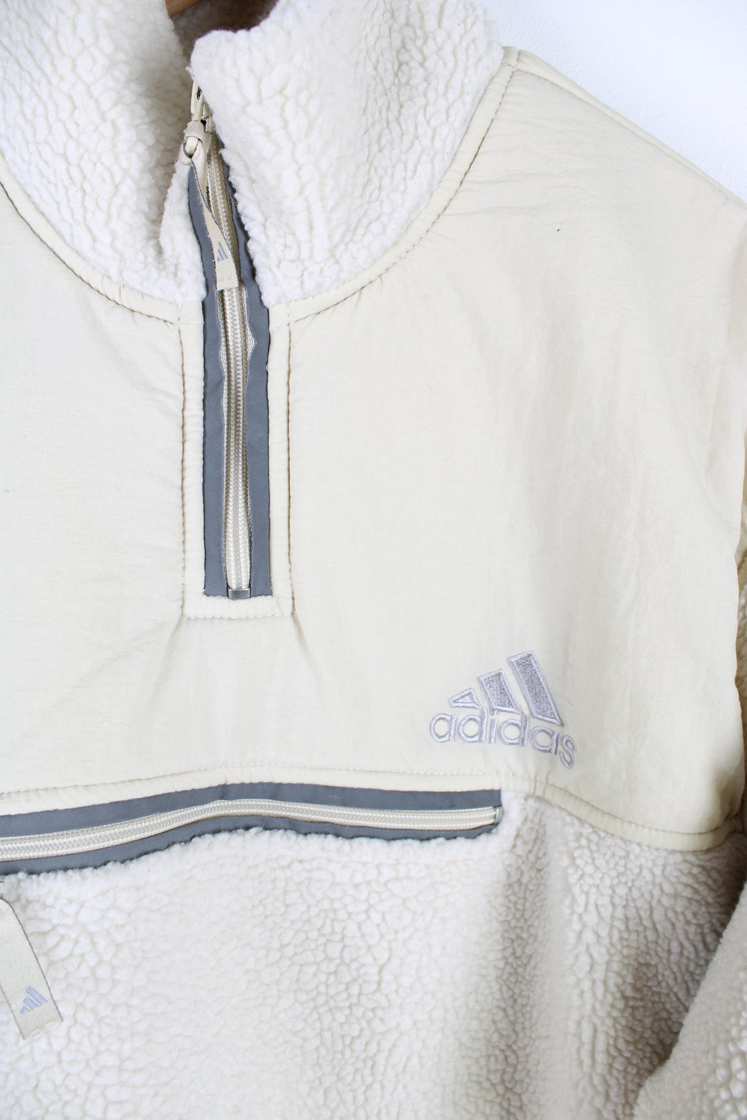 Beige Adidas pullover sherpa fleece with quarter zip and pouch pocket.