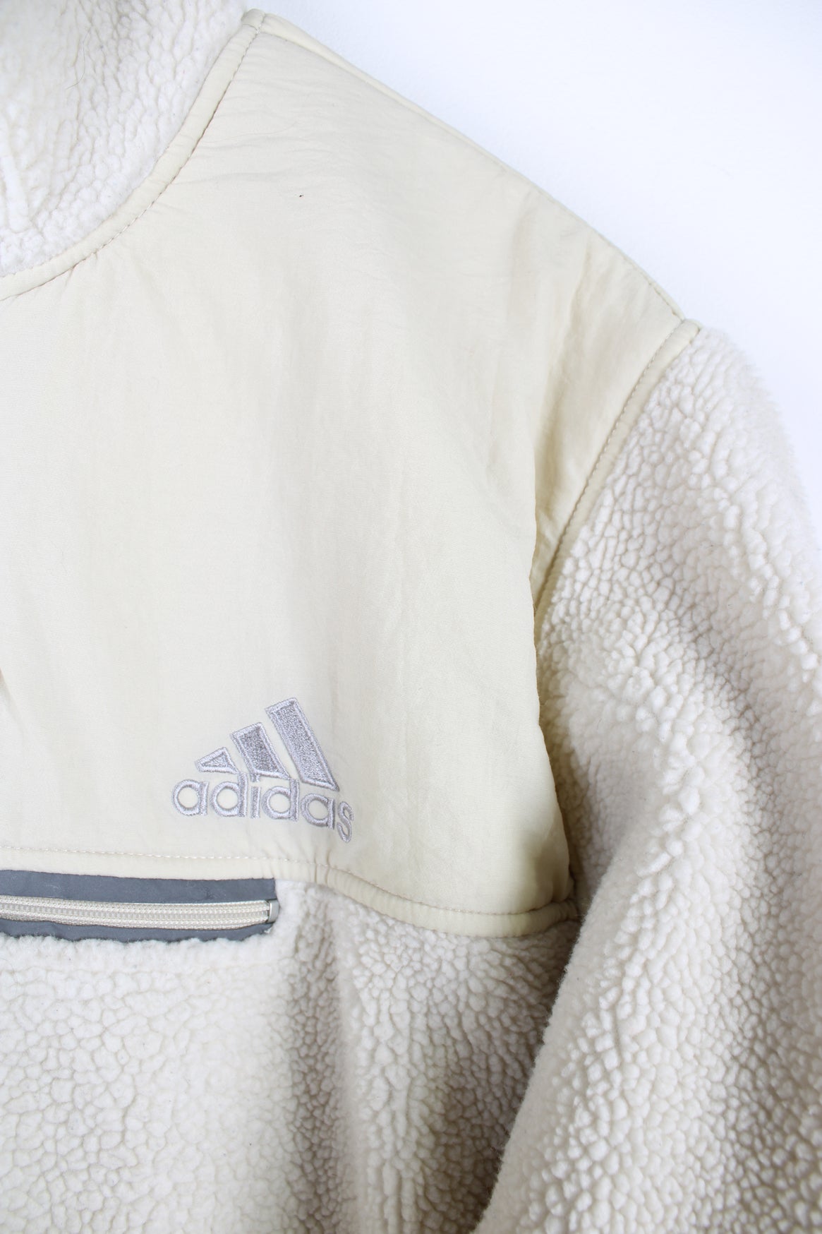 Beige Adidas pullover sherpa fleece with quarter zip and pouch pocket.