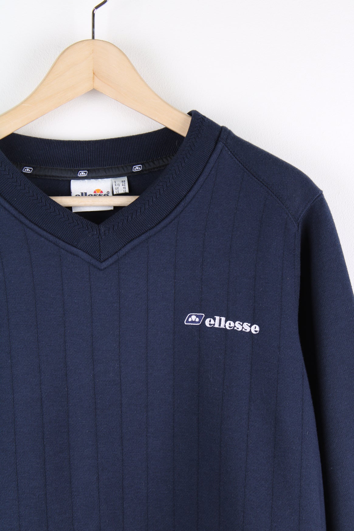 Blue vintage Ellesse v-neck sweatshirt with embroidered logo on the chest. 