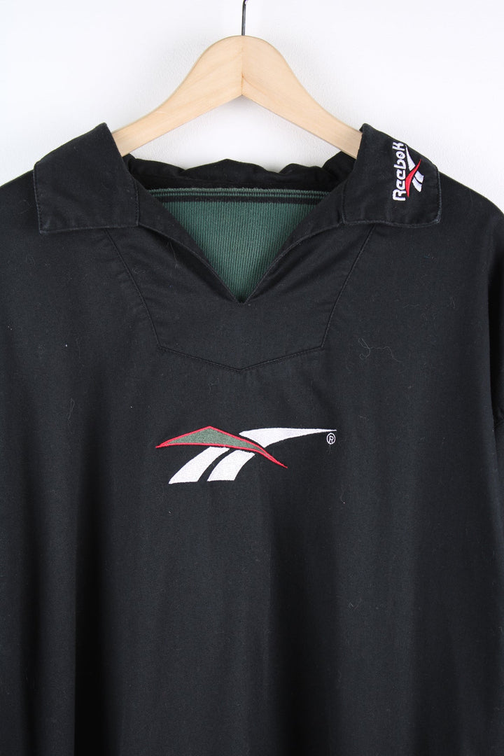 Vintage Reebok black pullover collared sweatshirt featuring embroidered logo across the chest.