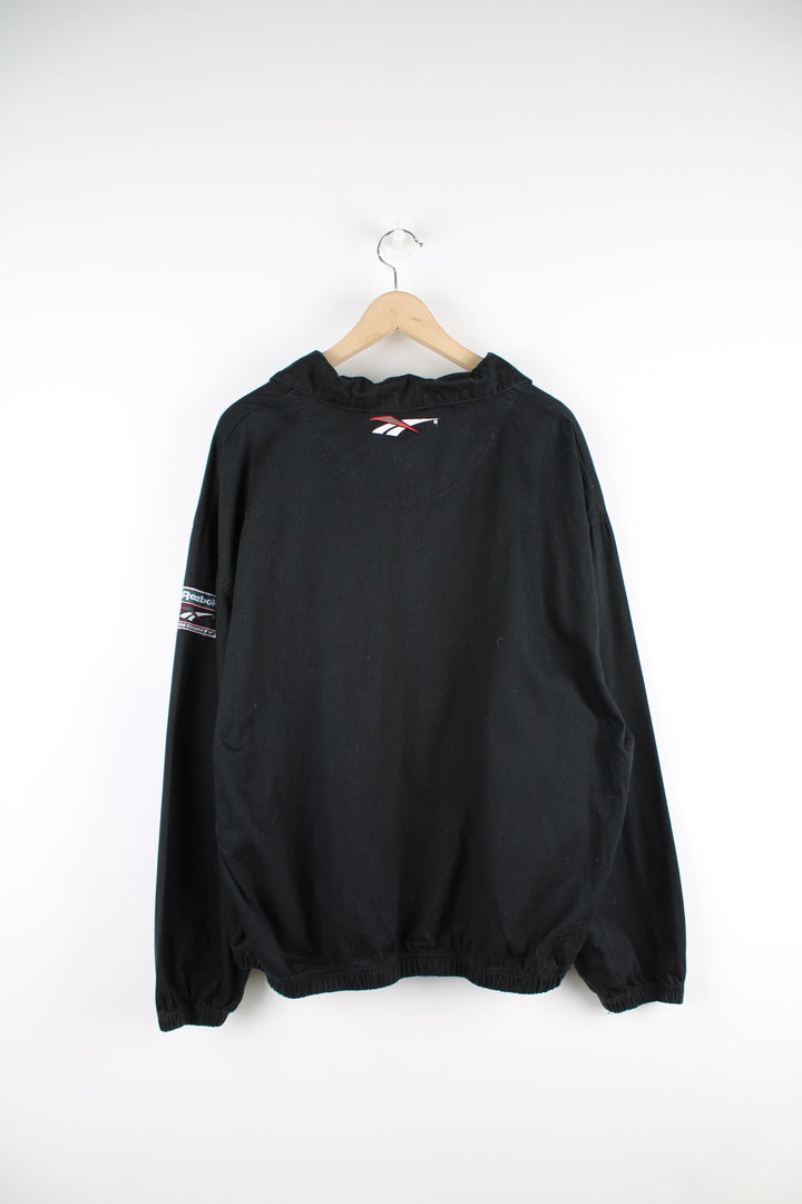 Vintage Reebok black pullover collared sweatshirt featuring embroidered logo across the chest.