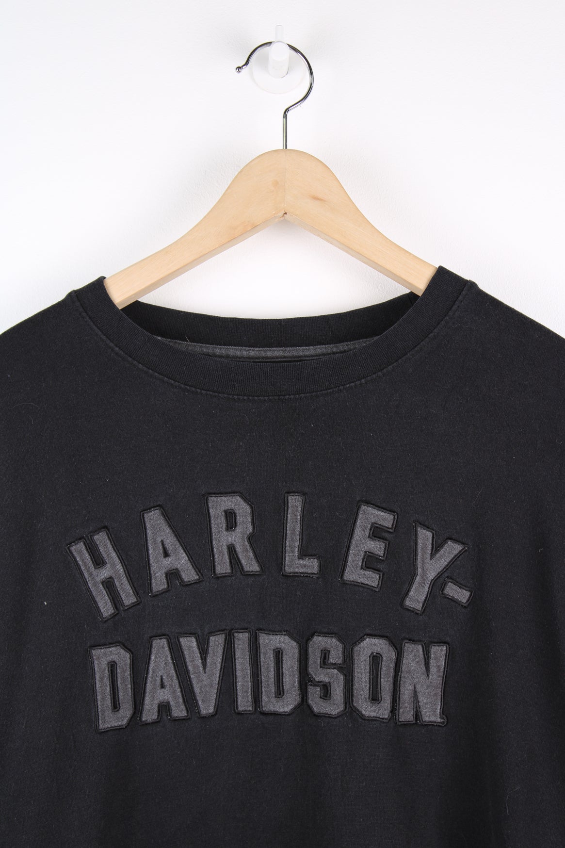 Vintage Harley Davidson black sweatshirt with grey spell-out logo across the chest and stripe feature down both sleeves.